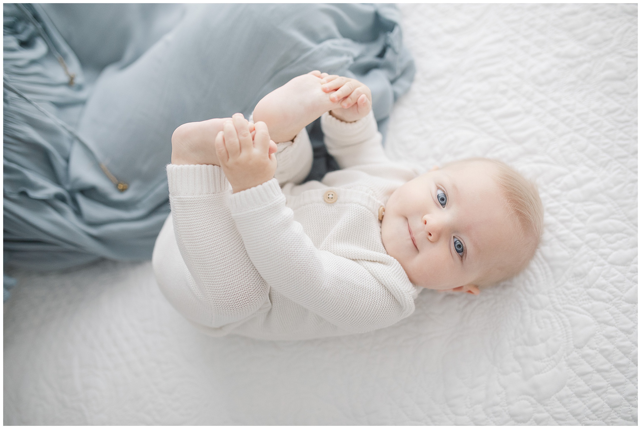 Baby boy discovers his feet. Photo by Little Sunshine Photography.