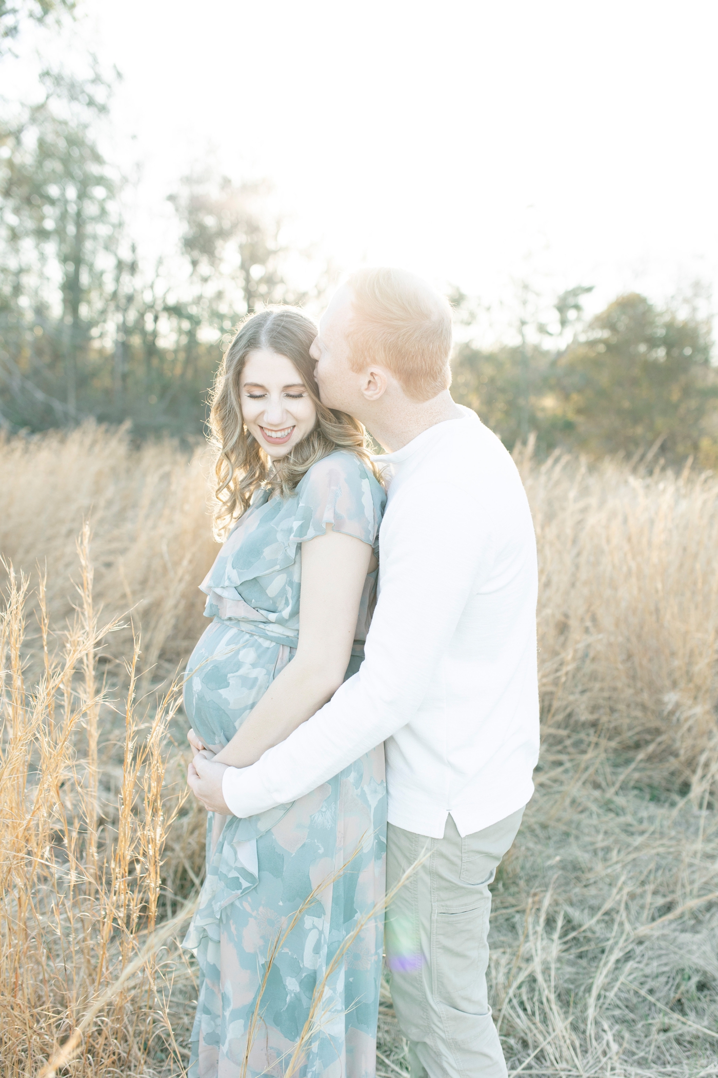 Golden hour sunset photos with new parents. Photo by Little Sunshine Photography.