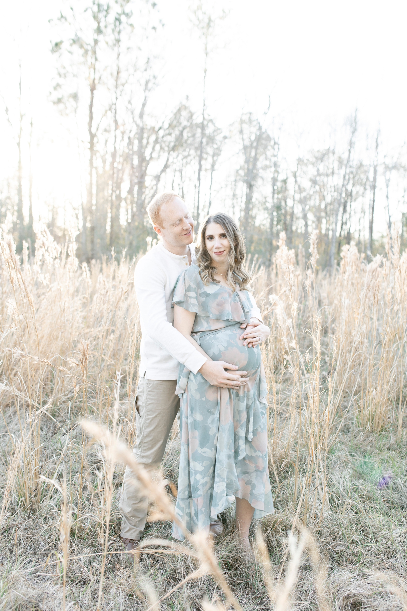 Sunset maternity session in tall golden grass. Photo by Little Sunshine Photography.