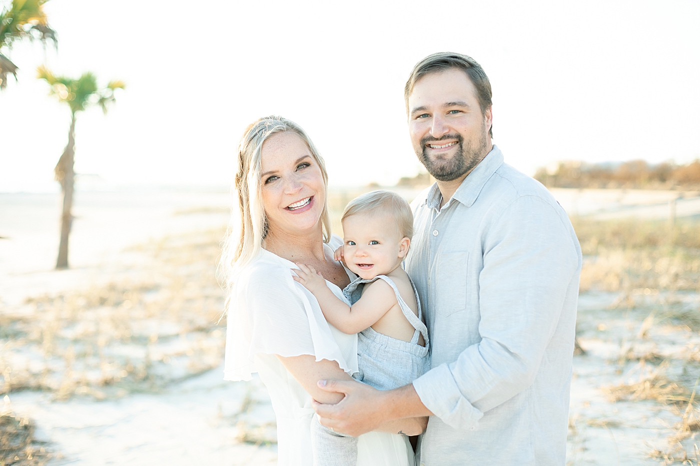 Family portrait at sunset on the beach. Photo by Little Sunshine Photography.