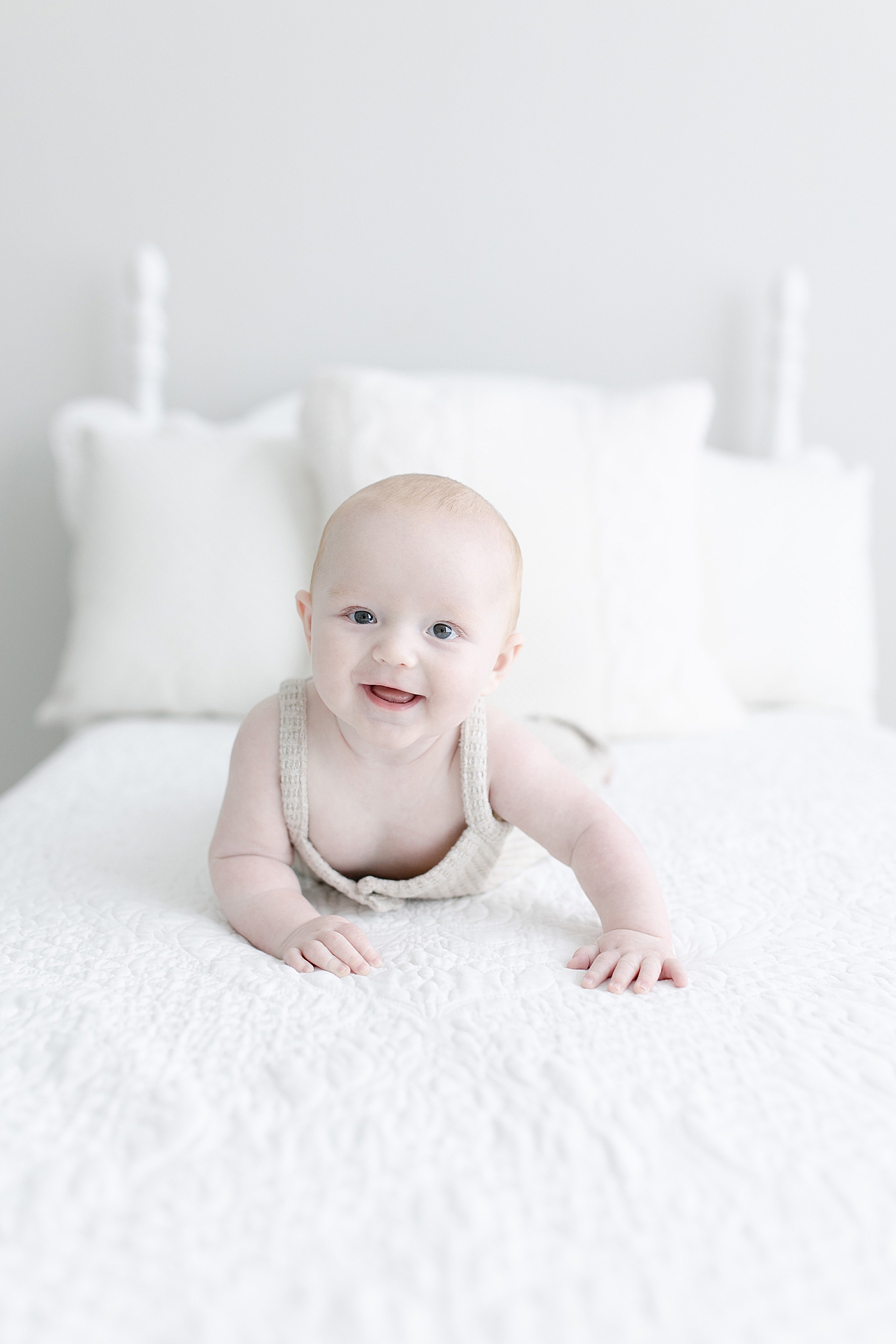 Baby boy laying on his stomach for milestone photos. Photo by Little Sunshine Photography