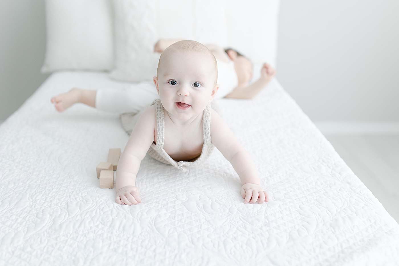 Brothers playing on bed. Photo by Hattiesburg baby photographer, Little Sunshine Photography.
