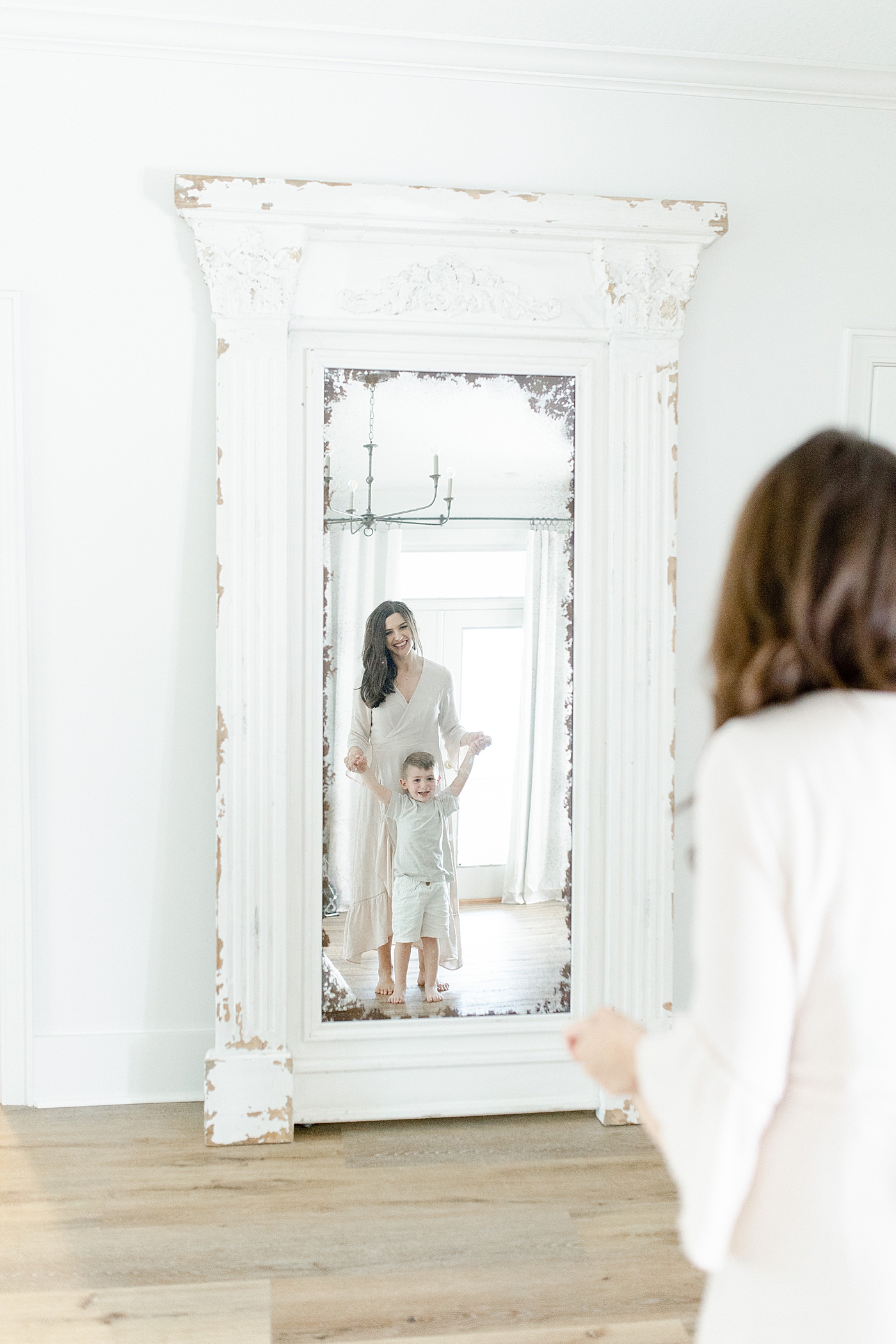 Mom looking into mirror with her son. Photo by Little Sunshine Photography