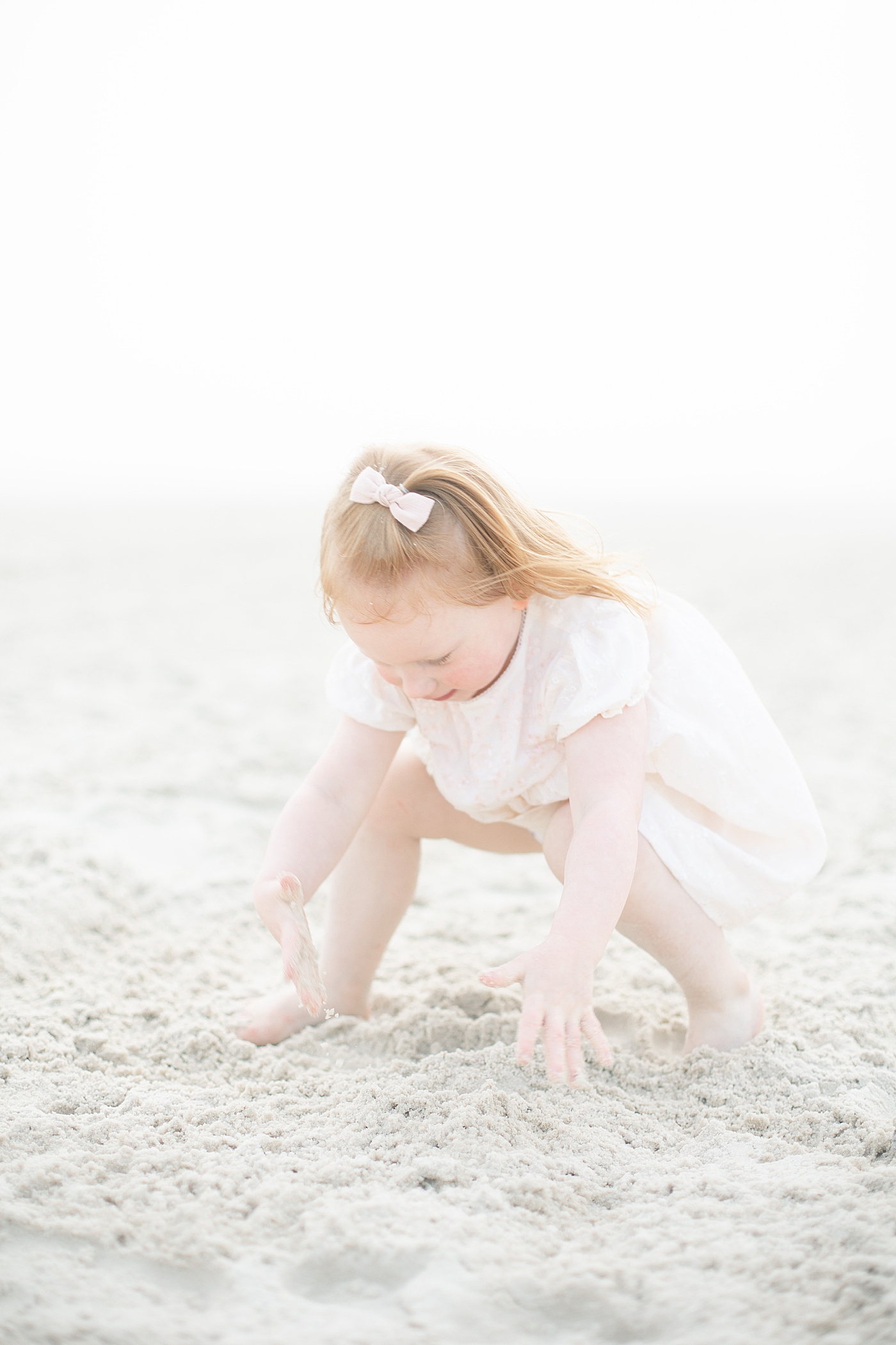 Toddler playing in the sand on the beach on the MS Gulf Coast. Photo by Little Sunshine Photography.