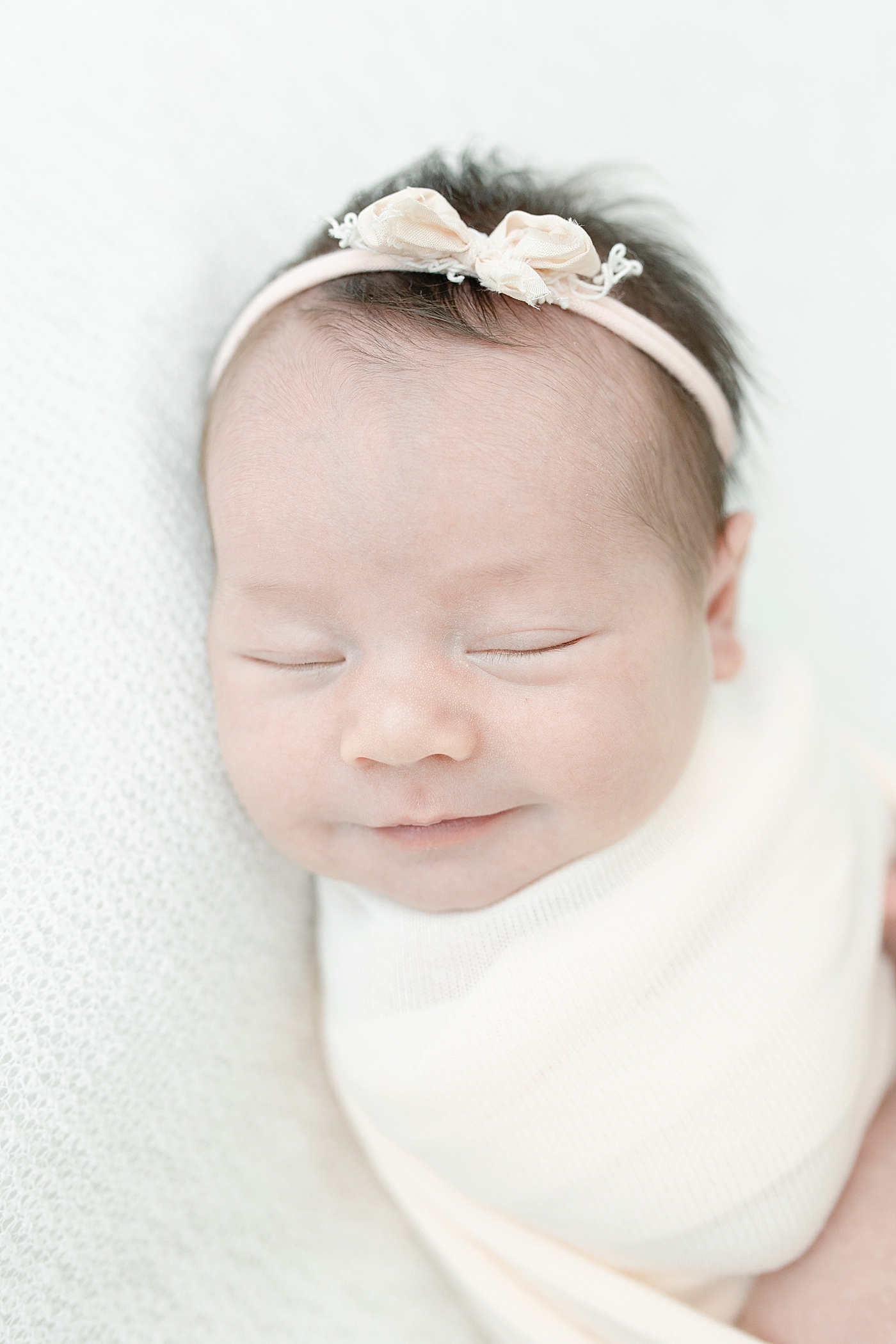 Baby girl smiling during newborn photos with Little Sunshine Photography