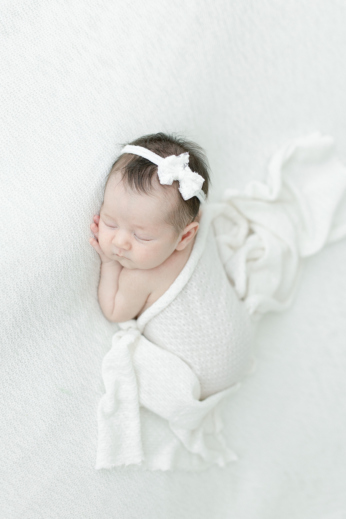 Baby girl laying on her stomach for photos with Ocean Springs newborn photographer, Little Sunshine Photography.