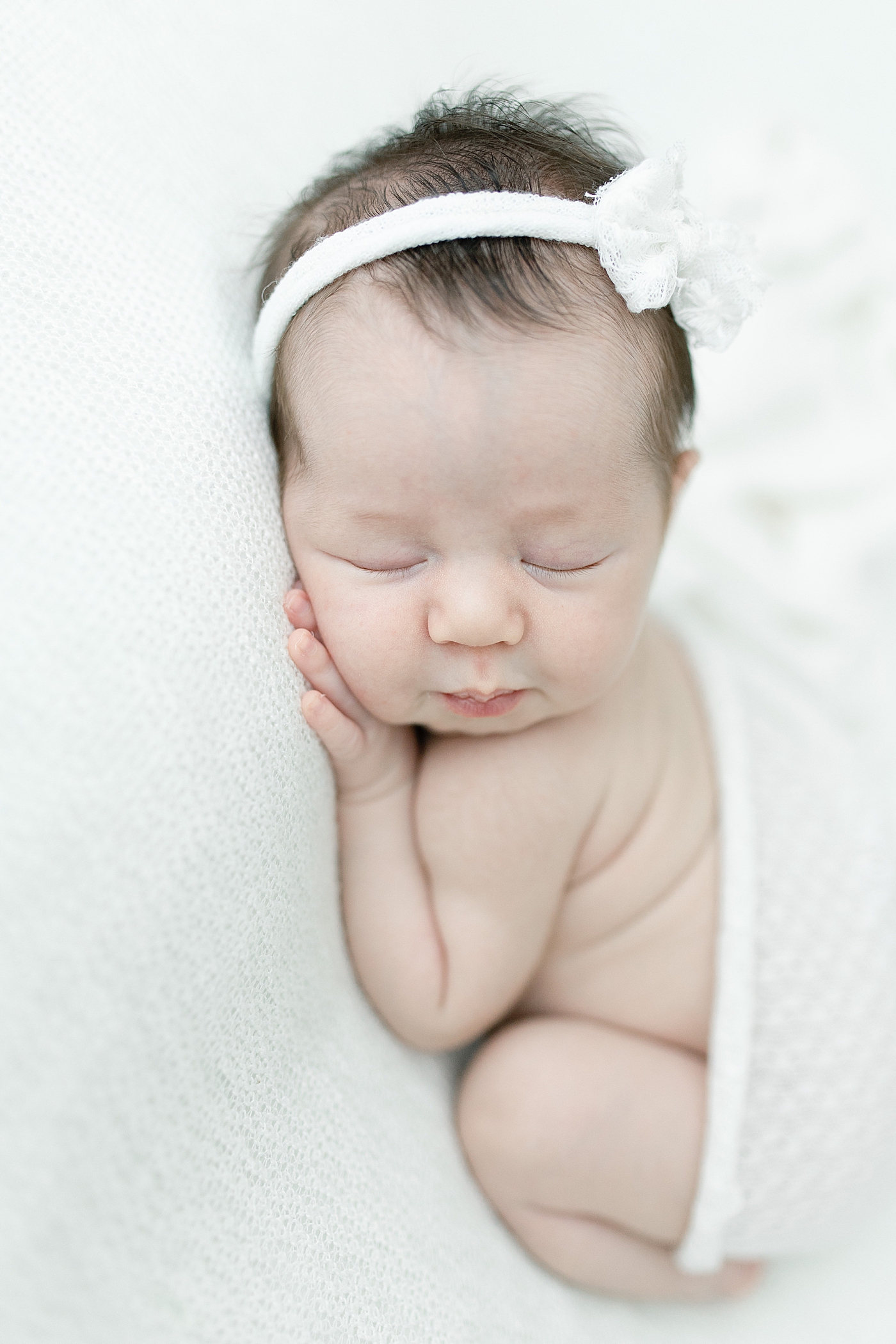 Baby girl with pouty lips during newborn session. Photo by Little Sunshine Photography