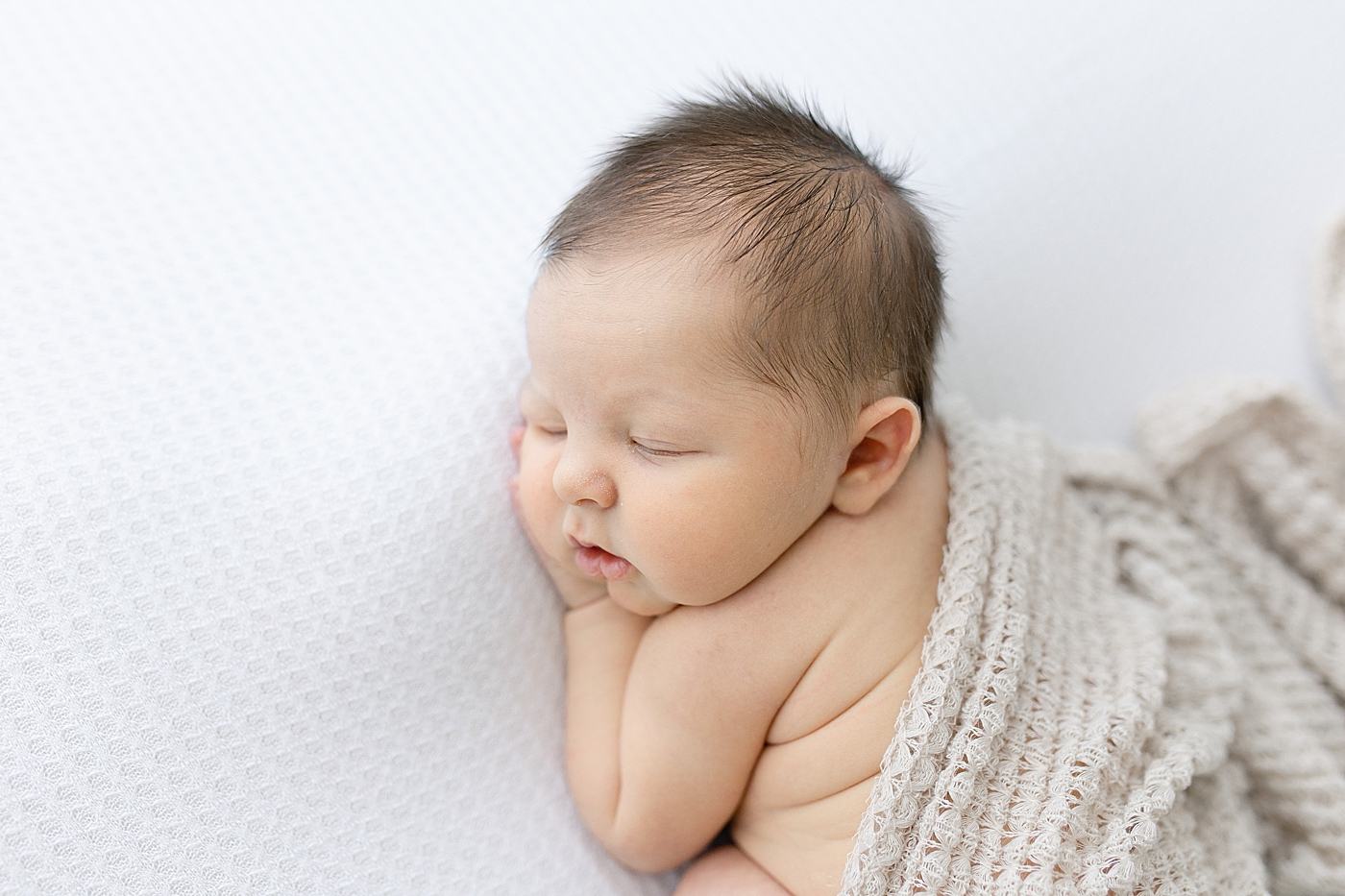 Newborn baby during in studio photo session. Photo by Little Sunshine Photography.
