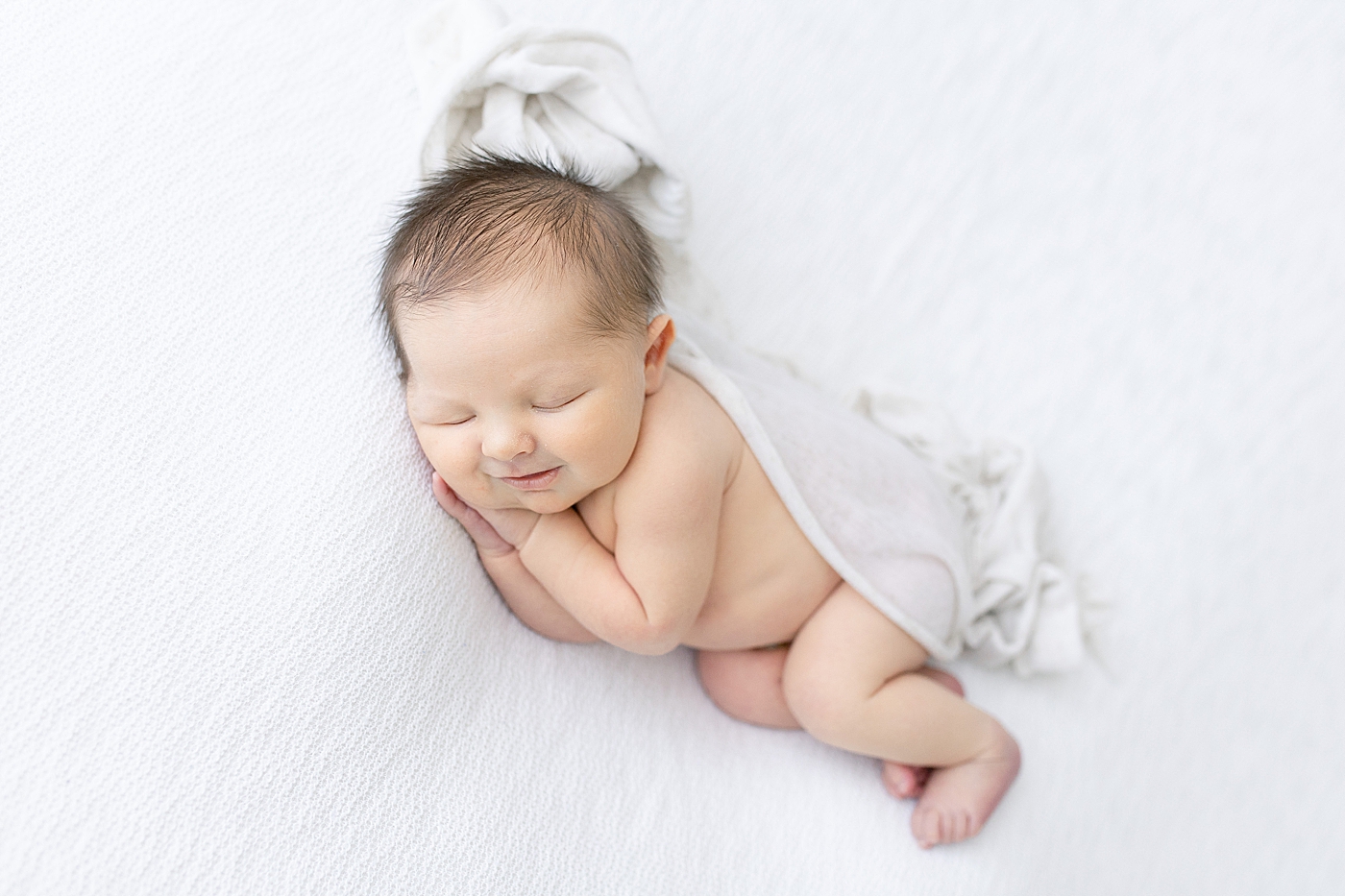 Newborn baby smiling during photos with Pascagoula Newborn Photographer, Little Sunshine Photography.