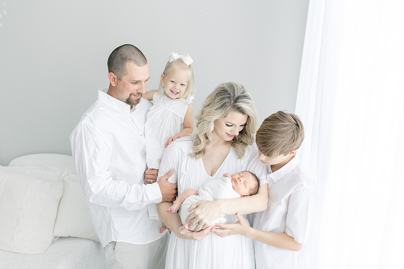 Family photo with newborn baby. Photo by Little Sunshine Photography.