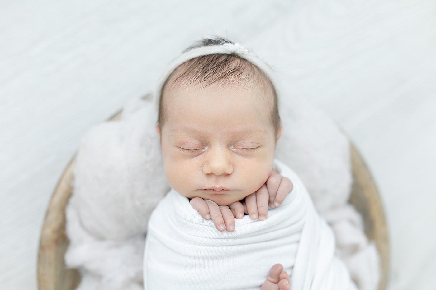 Newborn baby during studio session in swaddle | Photo by Little Sunshine Photography.