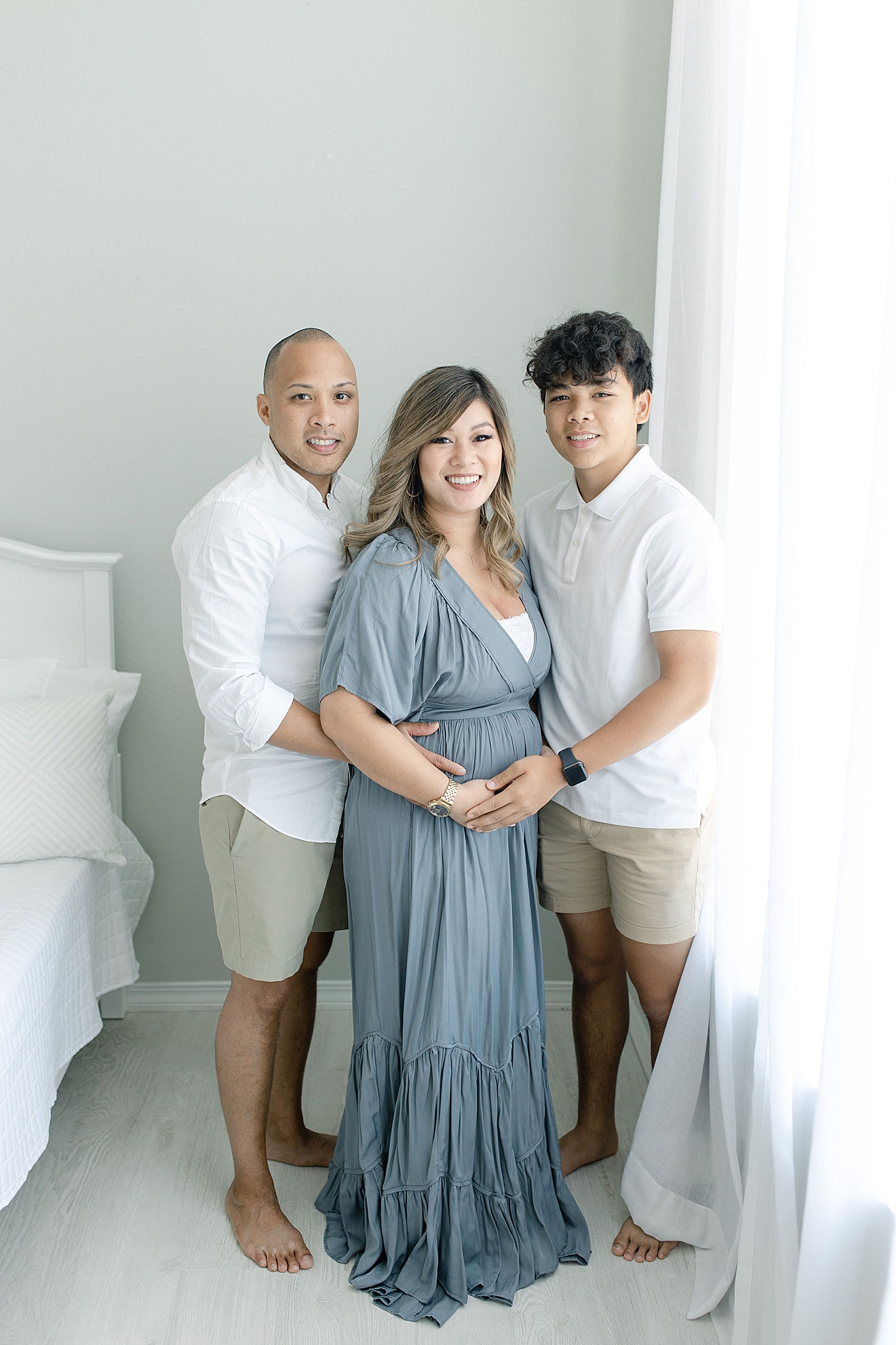 Family of three during maternity shoot in studio | Photo by Gulfport MS maternity photographer Little Sunshine Photography 