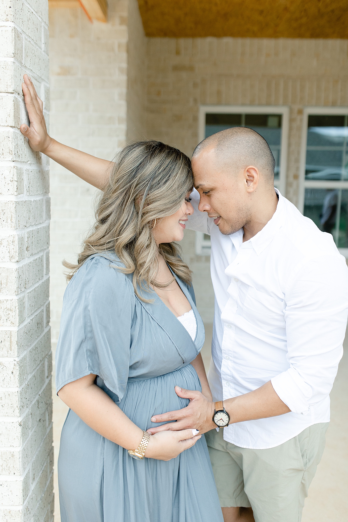 Mom and dad to be with foreheads together | Photo by MS Gulf Coast Photographer Little Sunshine Photography 