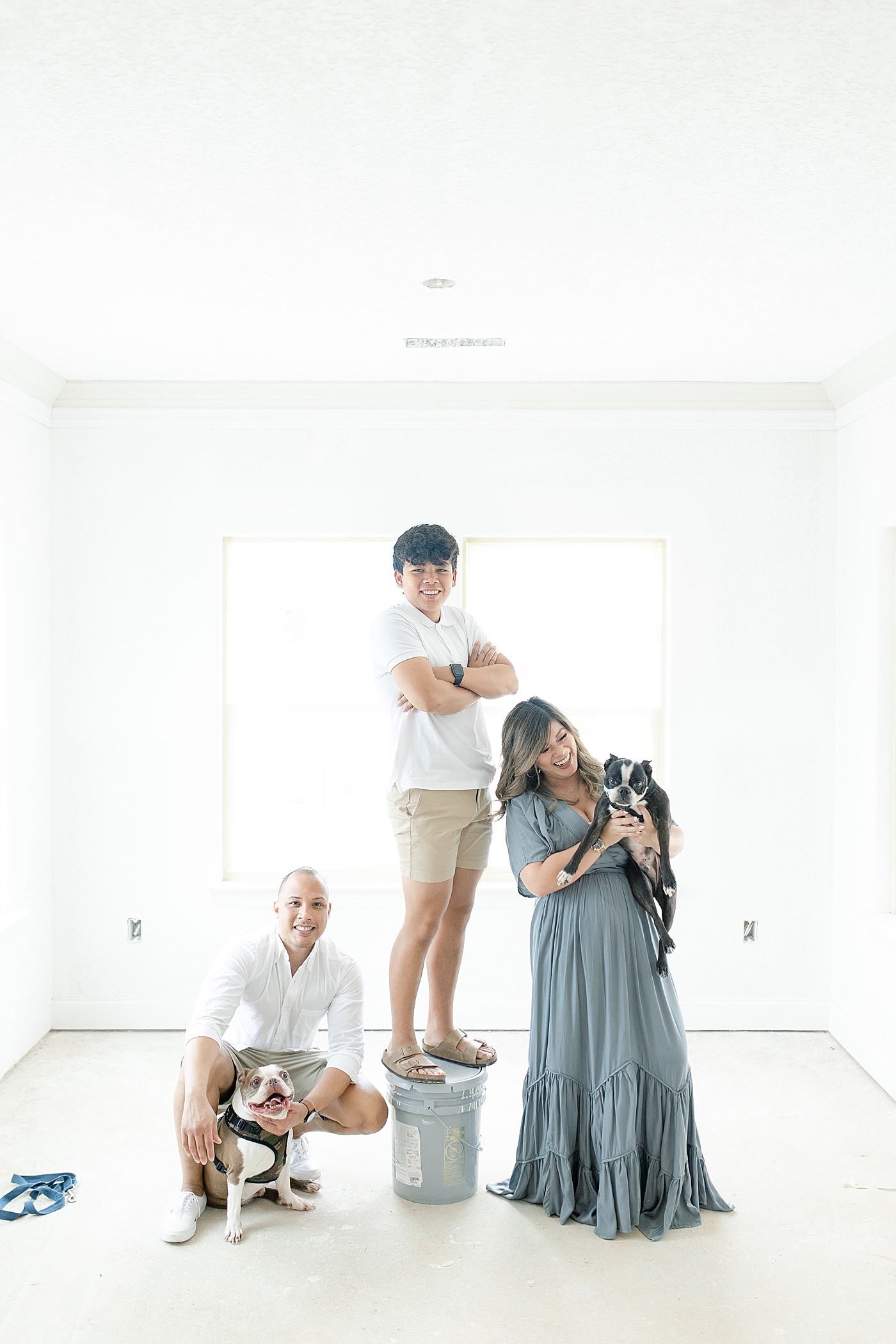 Family with dogs smile at camera in new home | Photo by Little Sunshine Photography 