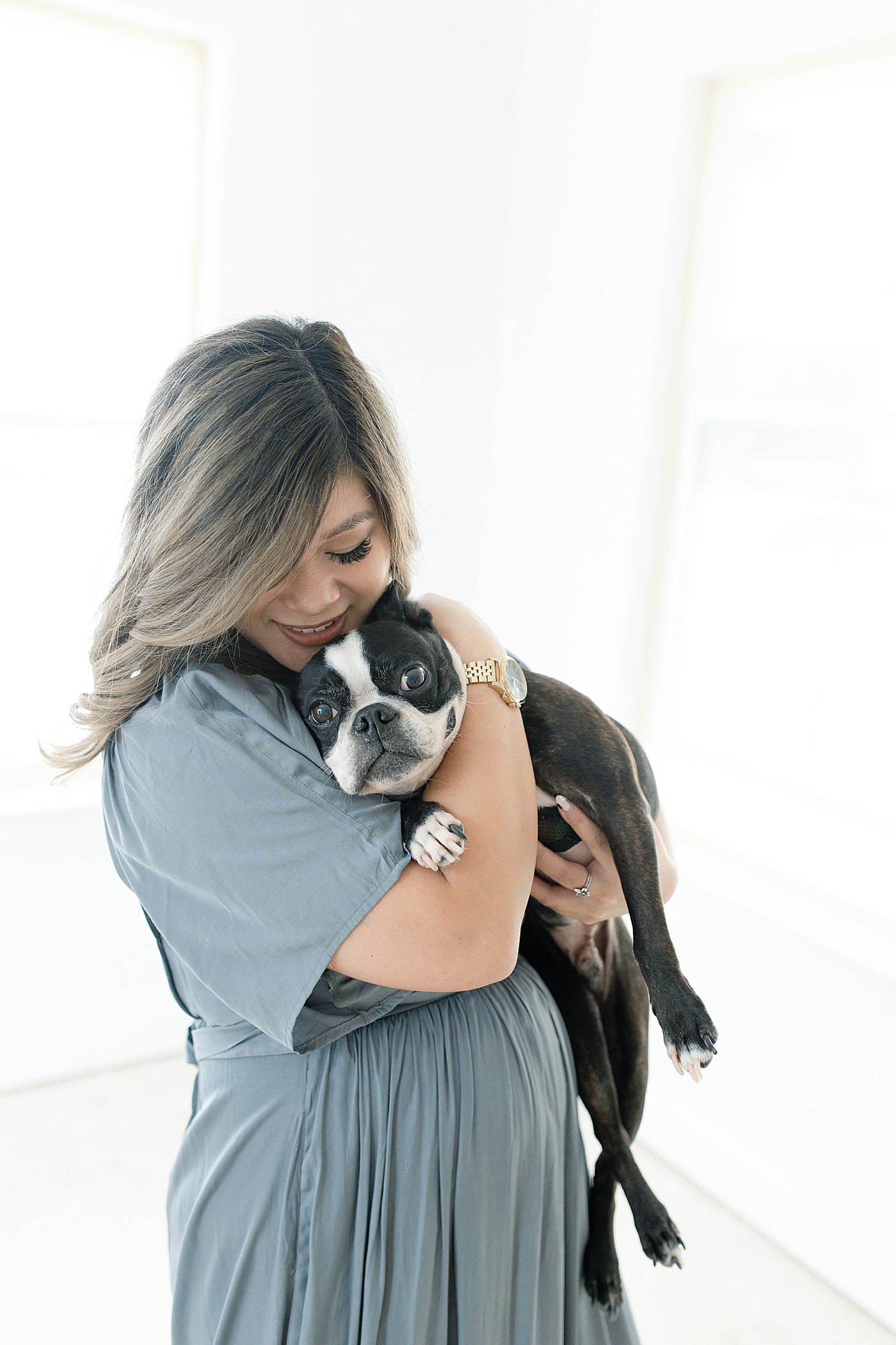Mom to be snuggling black and white dog | Photo by MS Gulf Coast Photographer Little Sunshine Photography 