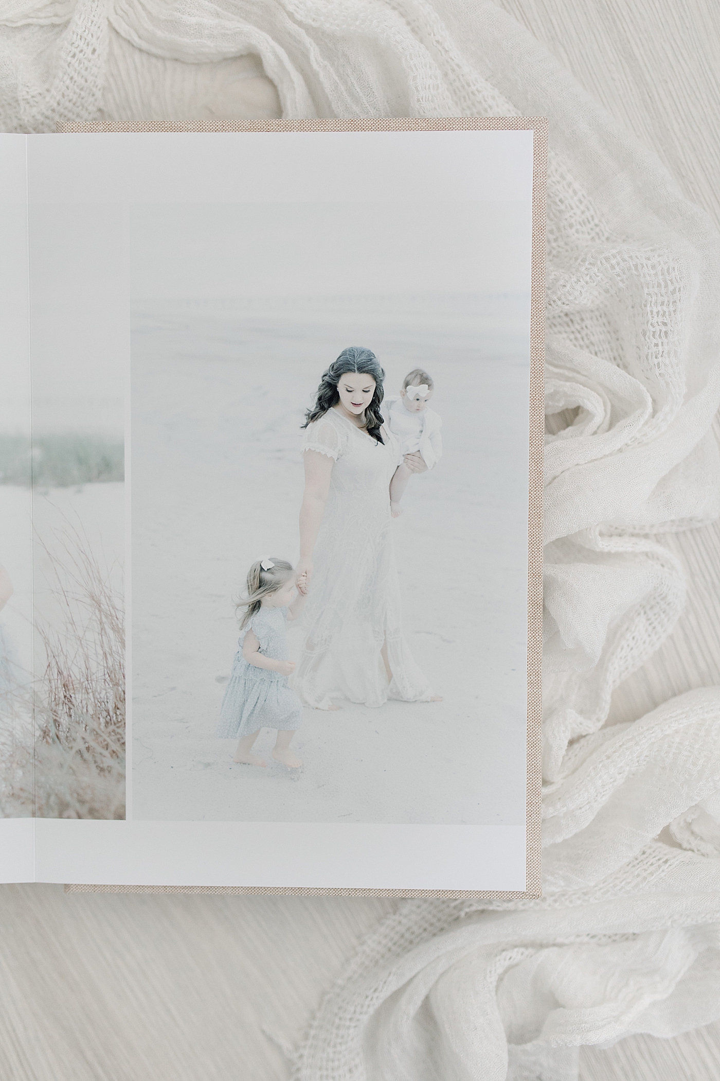 Detail of family photo album on white surface | Photo by Little Sunshine Photography