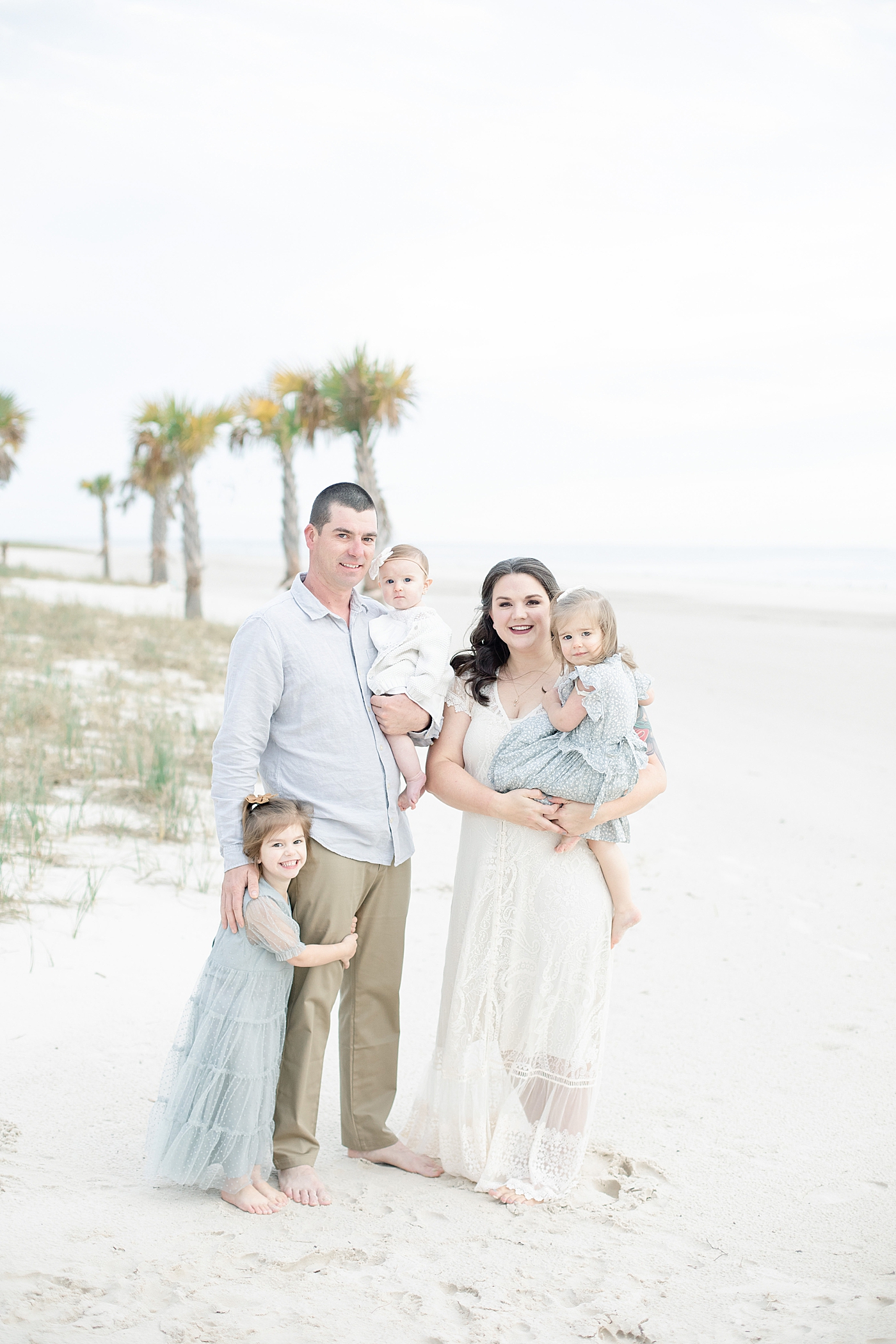 Family on the beach during photo session | Photo by Little Sunshine Photography
