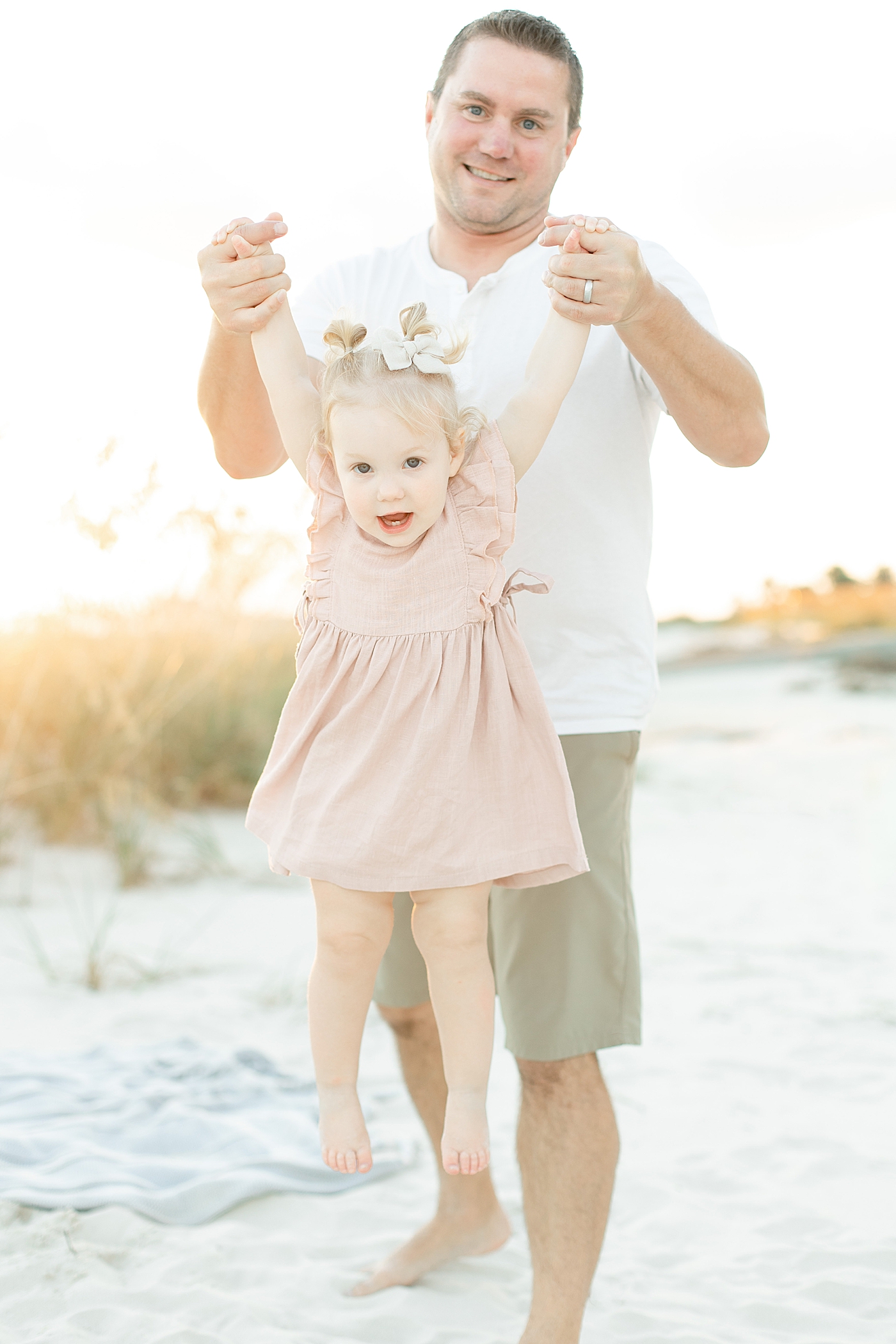 Dad playing with toddler baby girl on the beach | Photo by Bay St. Louis MS Family Photographer Little Sunshine Photography