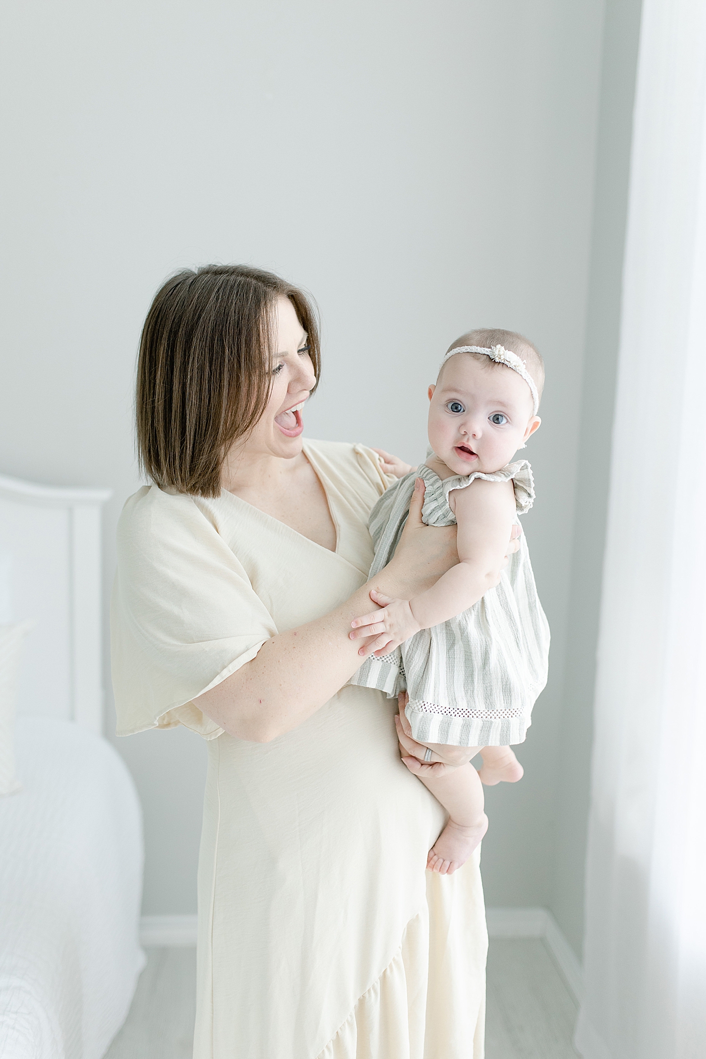 Mom and baby girl in stripes interacting | Photo by Hattiesburg MS Baby Photographer Little Sunshine Photography