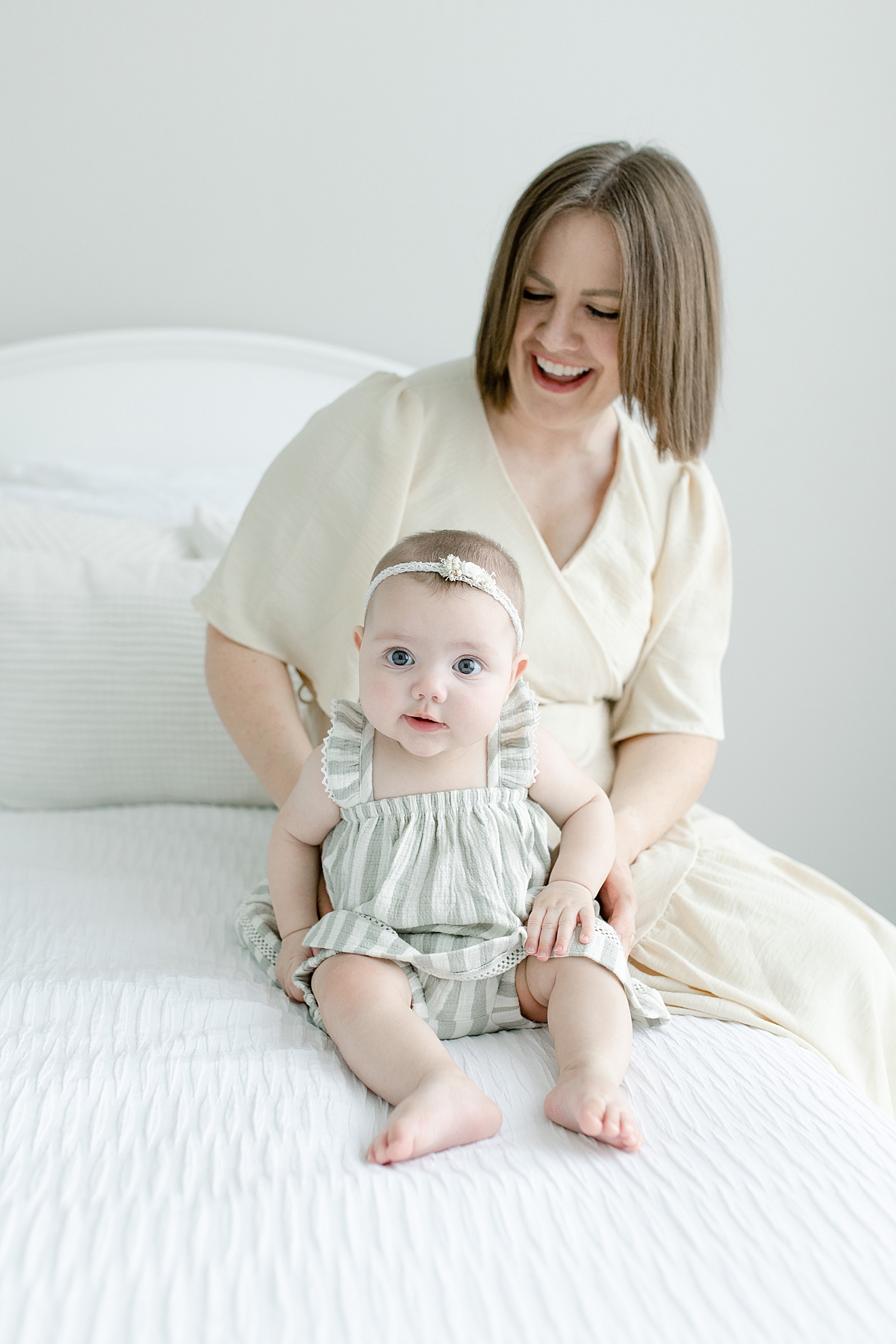 Baby girl in striped sitting up with mom | Photo by Hattiesburg MS Baby Photographer Little Sunshine Photography