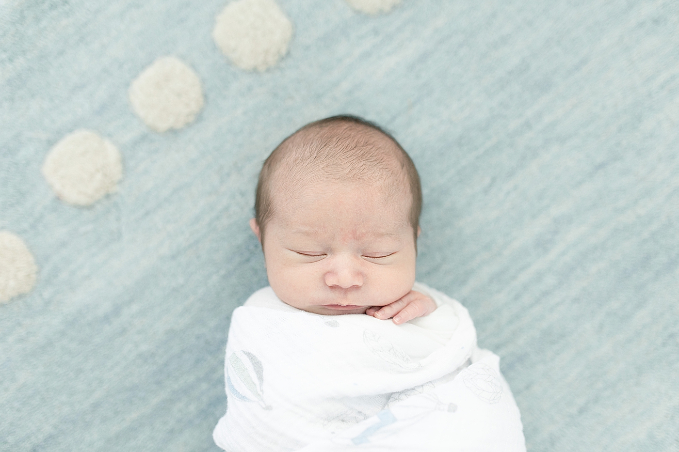 Baby boy in white swaddle sleeping | Photo by Long Beach Newborn Photographer Little Sunshine Photography