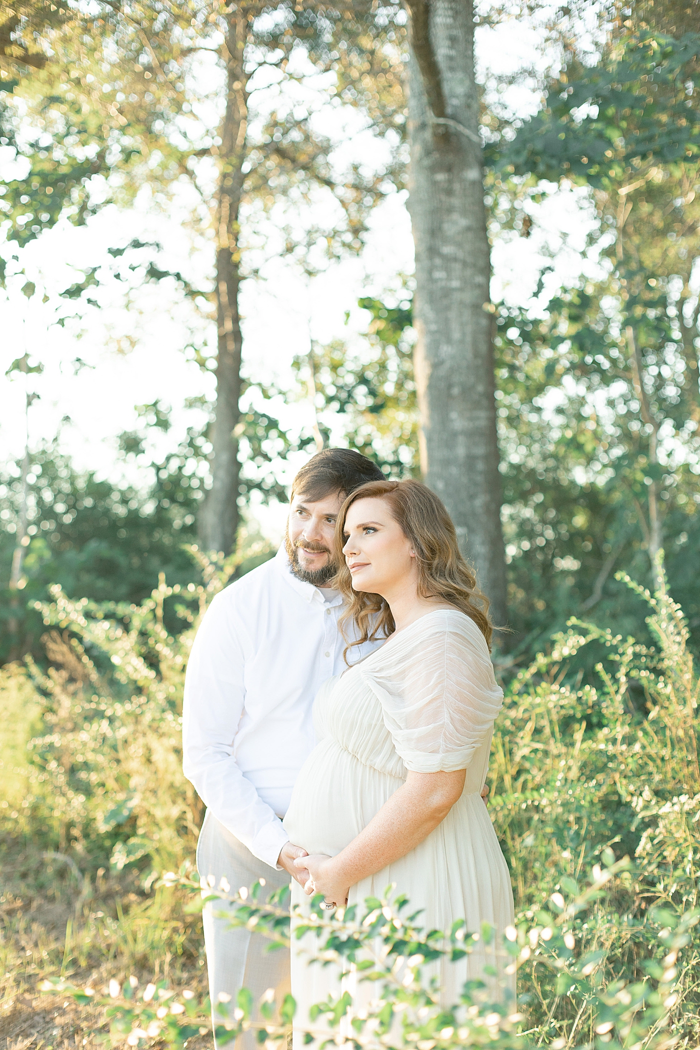 Mother and father to be cradling moms belly | Photo by Little Sunshine Photography 