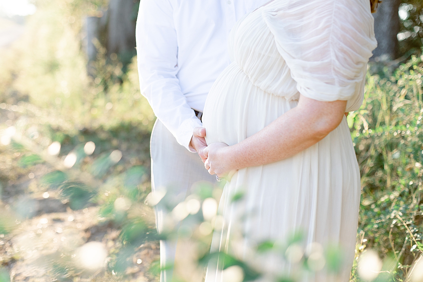 Detail image of mother and father cradling moms belly | Photo by Little Sunshine Photography 