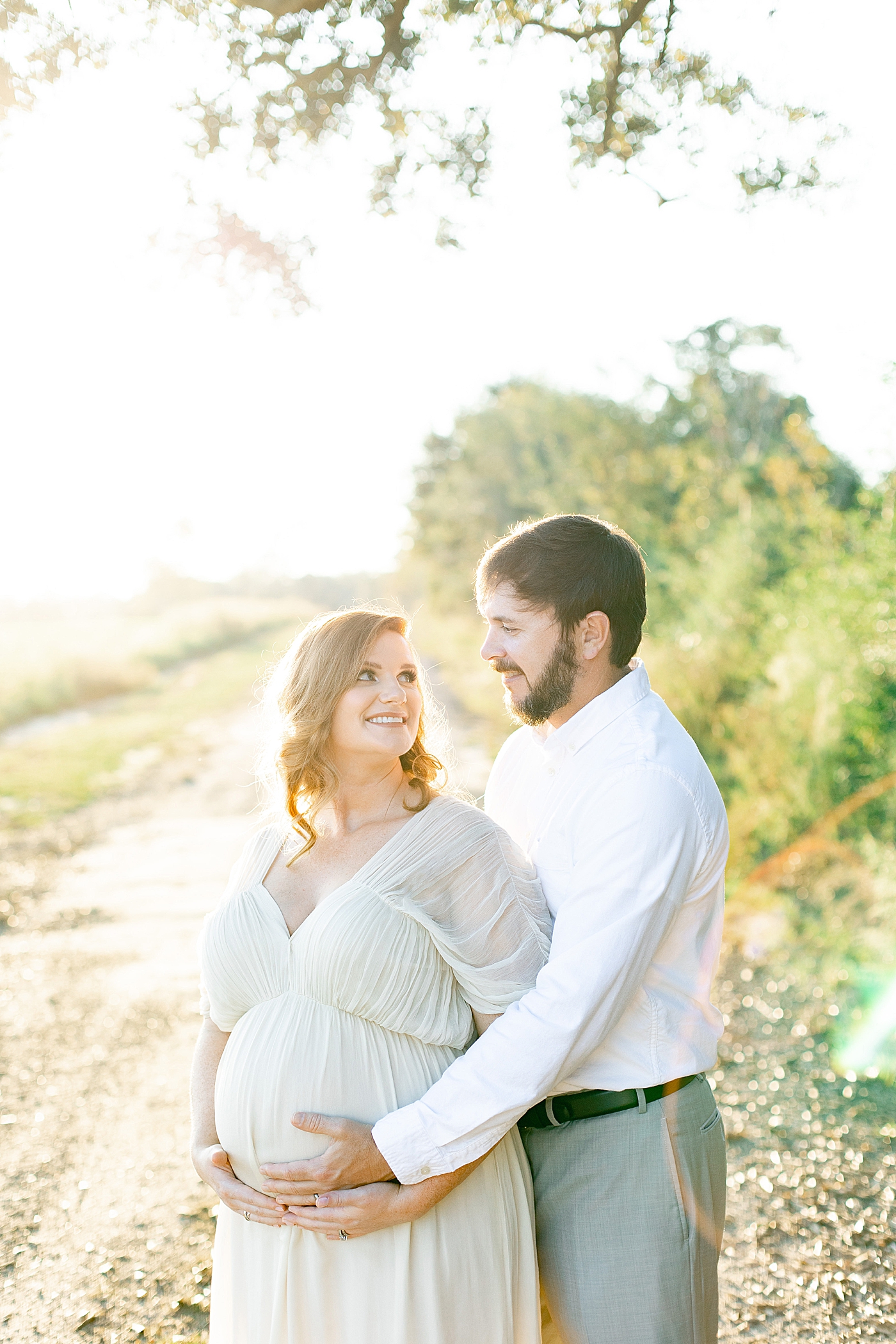 Mother and father to be smiling at each other | Photo by Ocean Springs MS Maternity Photographer Little Sunshine Photography 