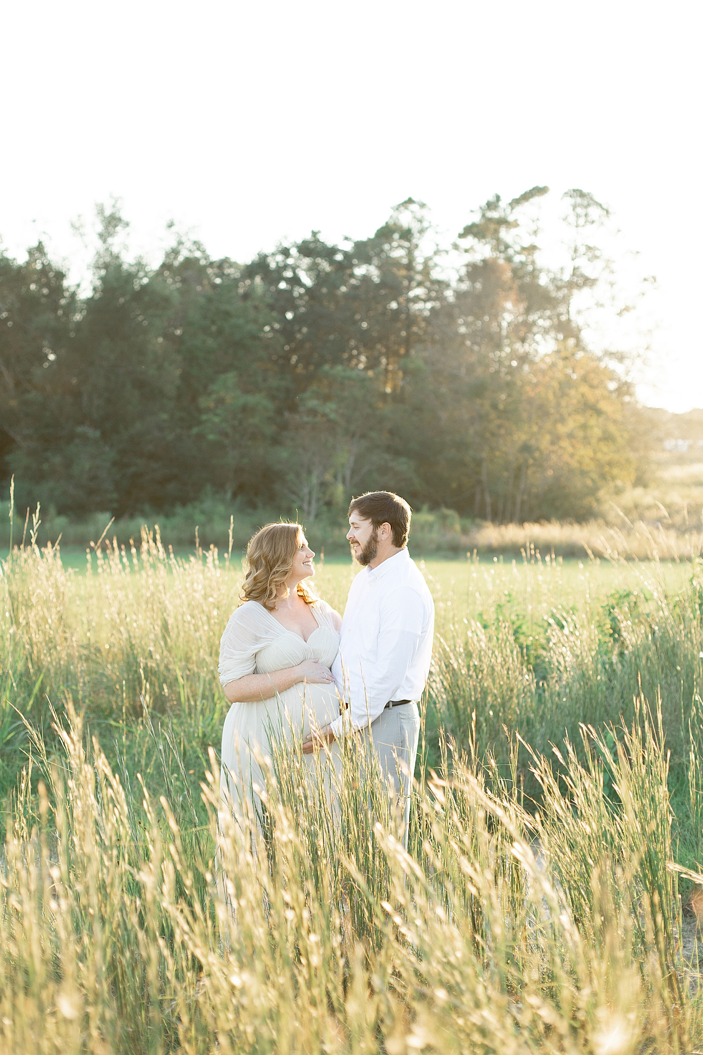 Mother and father to be smiling at each other | Photo by Little Sunshine Photography 