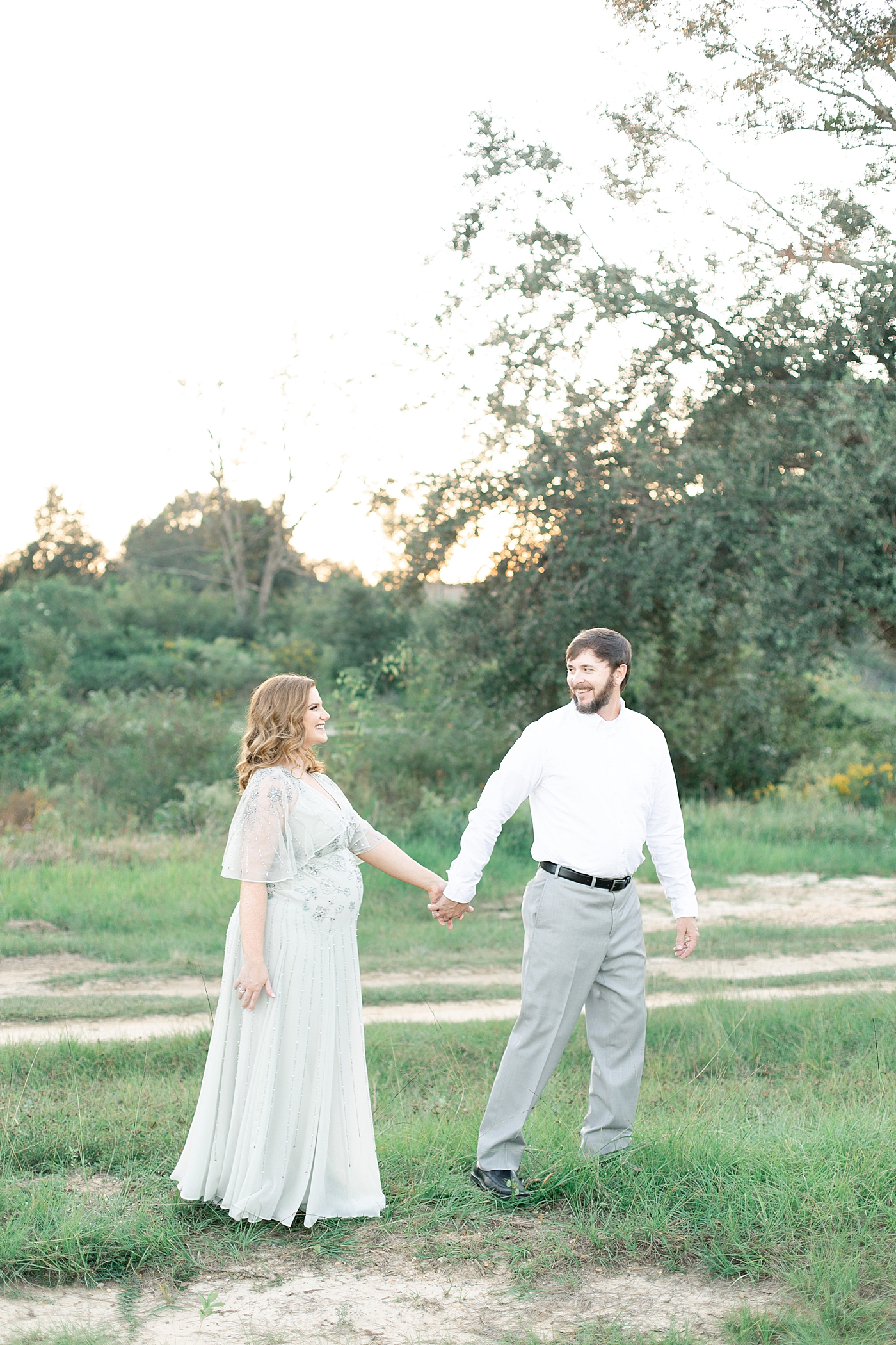 Mother and father to be walking on a path | Photo by Ocean Springs MS Maternity Photographer Little Sunshine Photography 