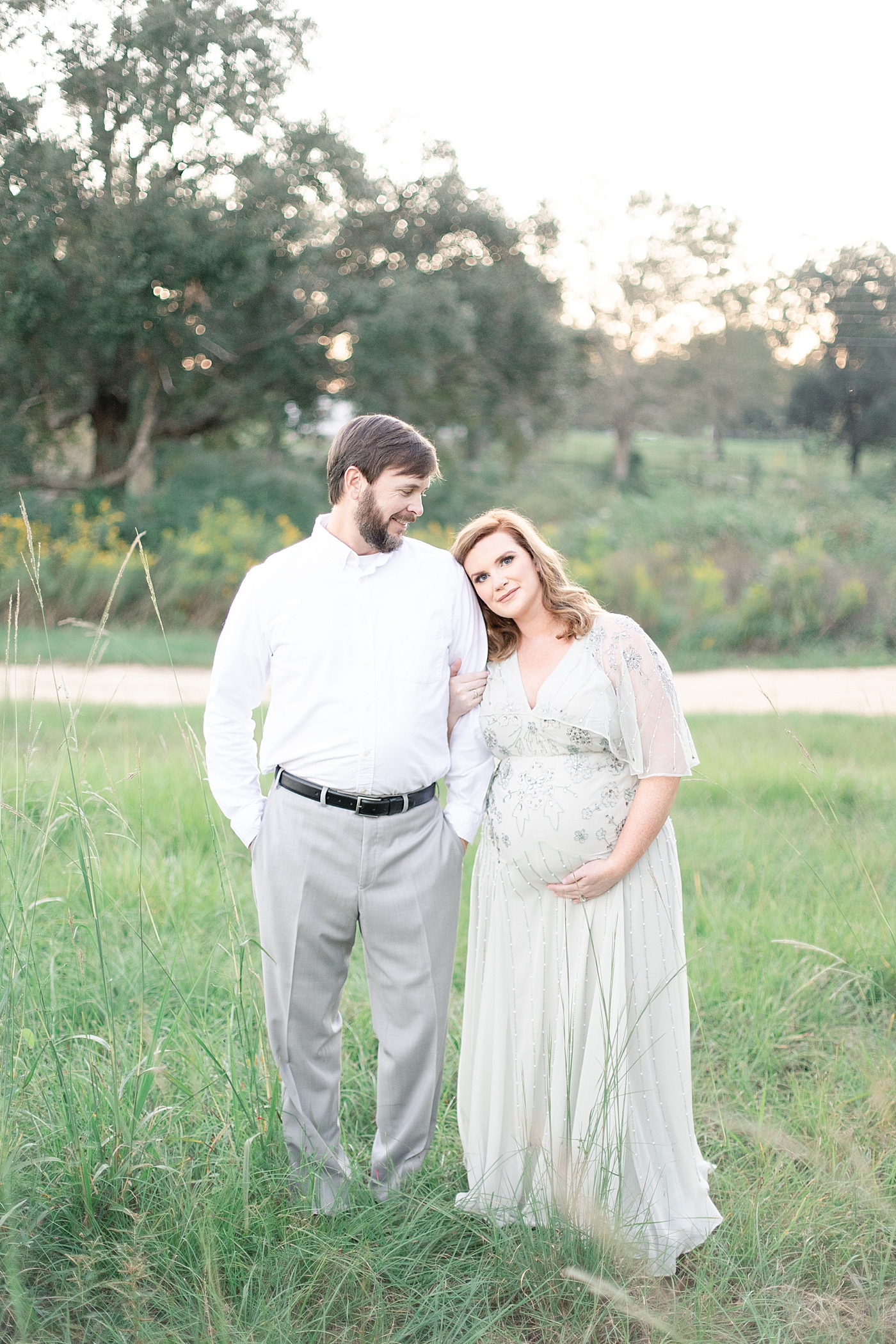 Mother to be leaning her head on father to be shoulder | Photo by Ocean Springs MS Maternity Photographer Little Sunshine Photography 