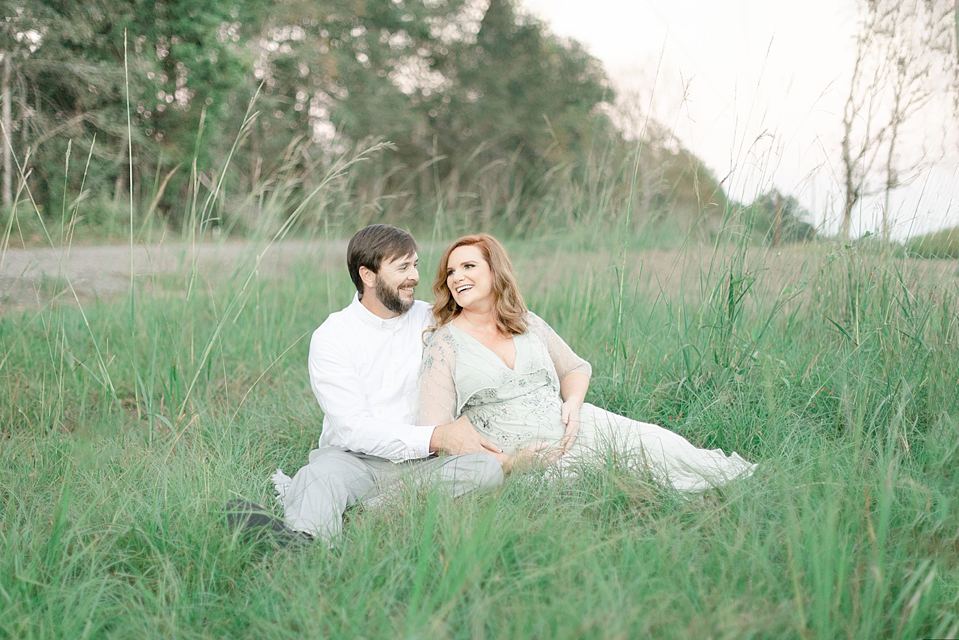 Mother and father laughing together | Photo by Ocean Springs MS Maternity Photographer Little Sunshine Photography 