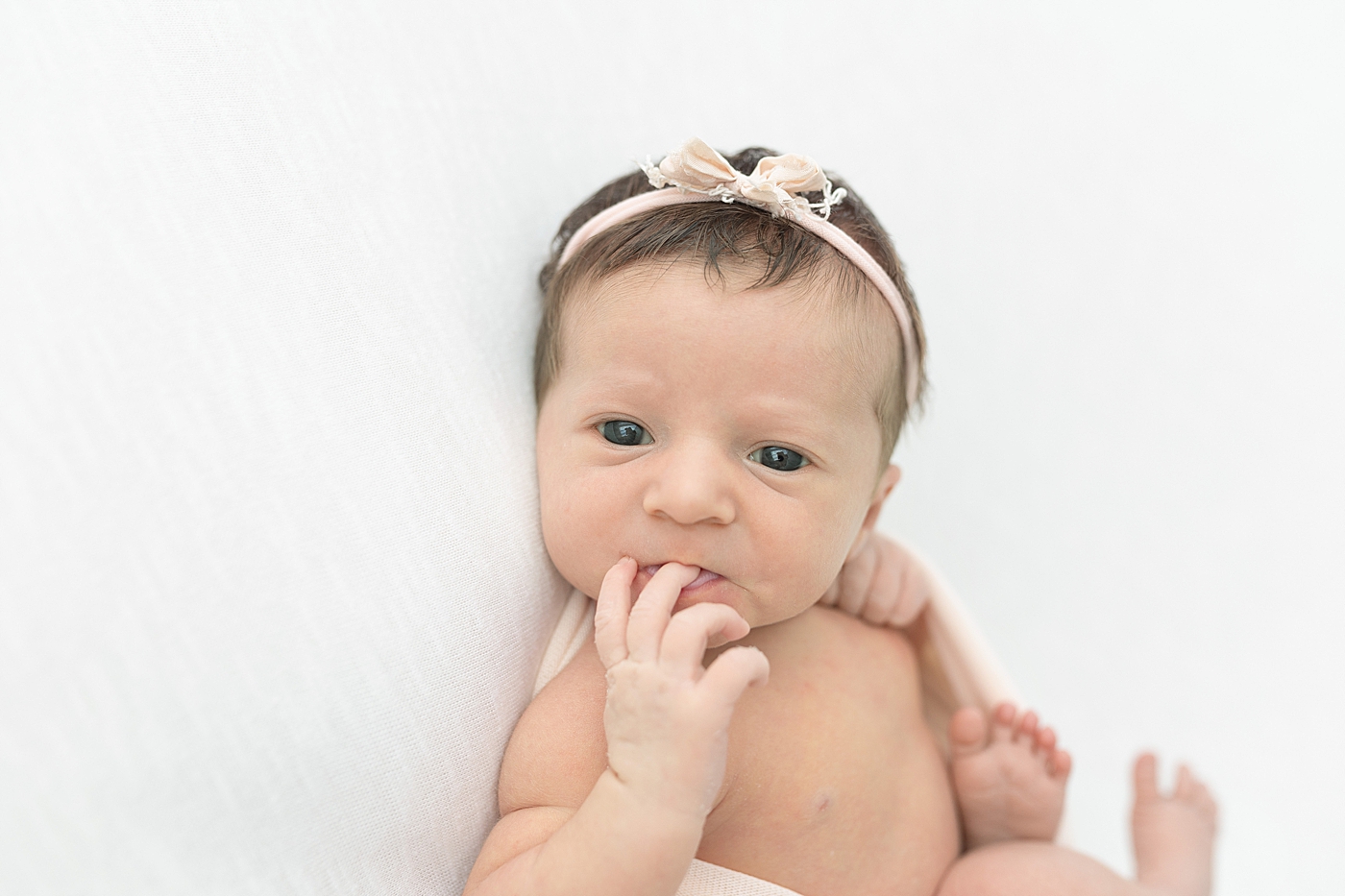 Alert newborn baby girl in pink headband | Photo by Little Sunshine Photography 