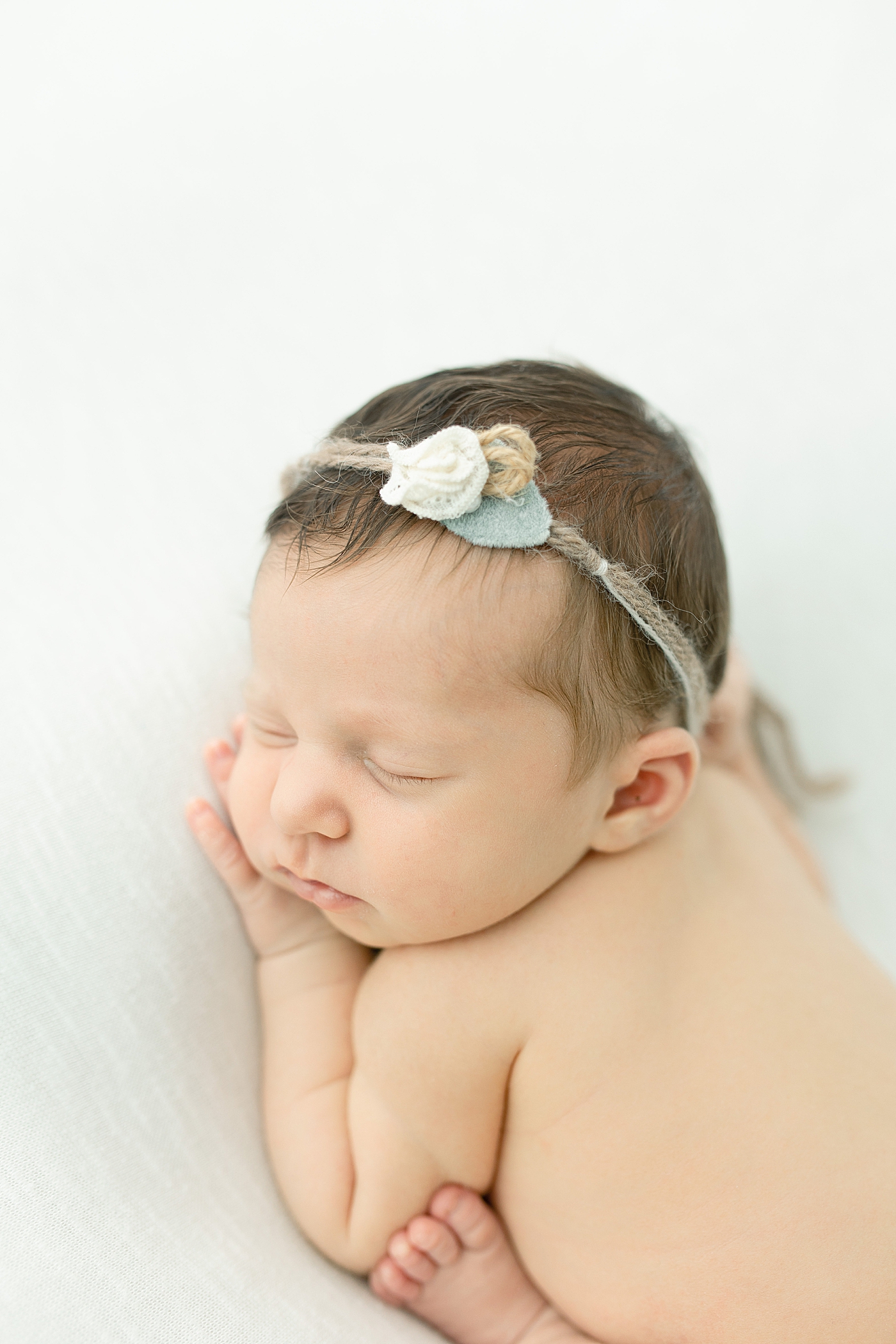Newborn baby girl with floral headband | Photo by Little Sunshine Photography 