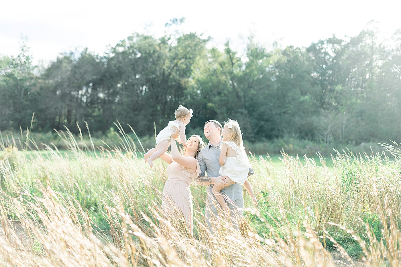 Family standing in a light filled field | Photo by Hattiesburg MS family photographer Little Sunshine Photography 