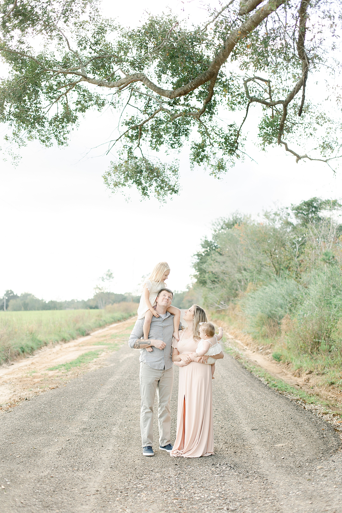 Family interacting while walking on a dirt path | Photo by Little Sunshine Photography 