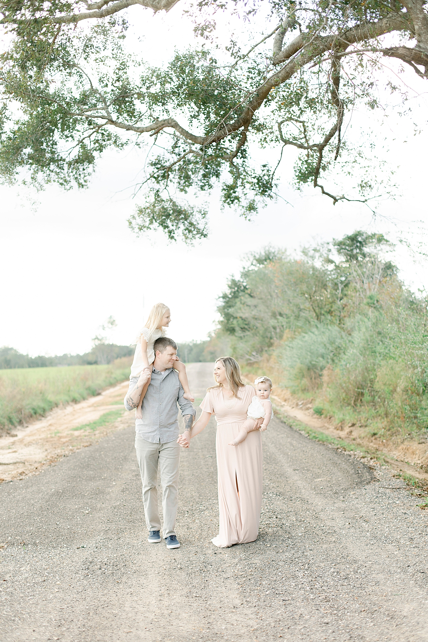 Family walking together on a dirt path | Photo by Hattiesburg MS family photographer Little Sunshine Photography 
