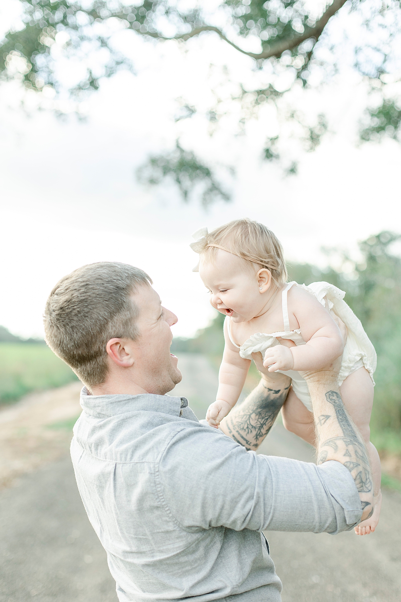 Dad playing airplane with baby girl | Photo by Little Sunshine Photography 