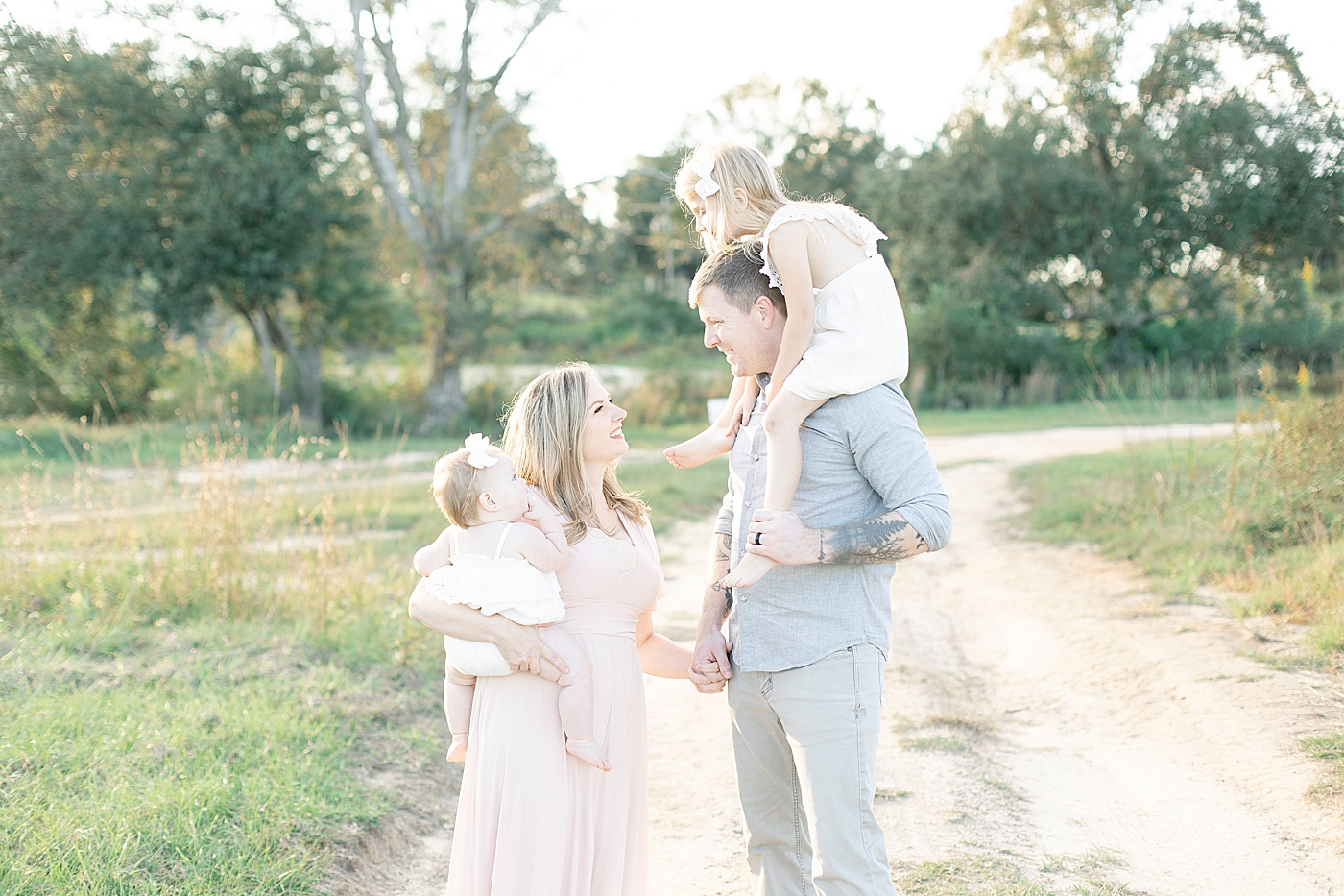 Family walking together on a dirt path | Photo by Little Sunshine Photography