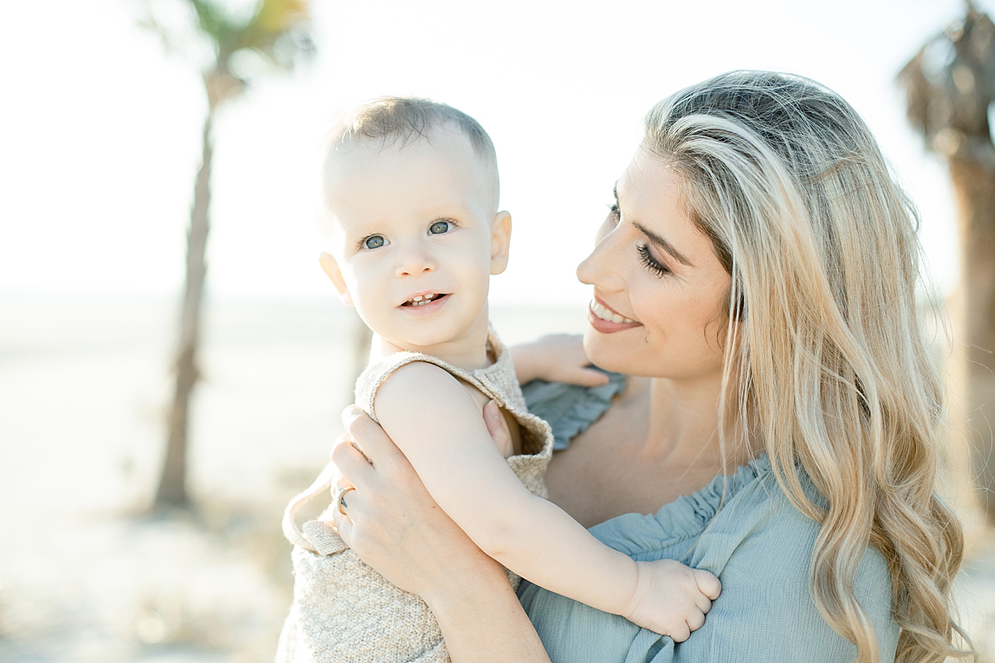 Mom smiling at her baby on the beach | Photo by Ocean Springs Family Photographer Little Sunshine Photography