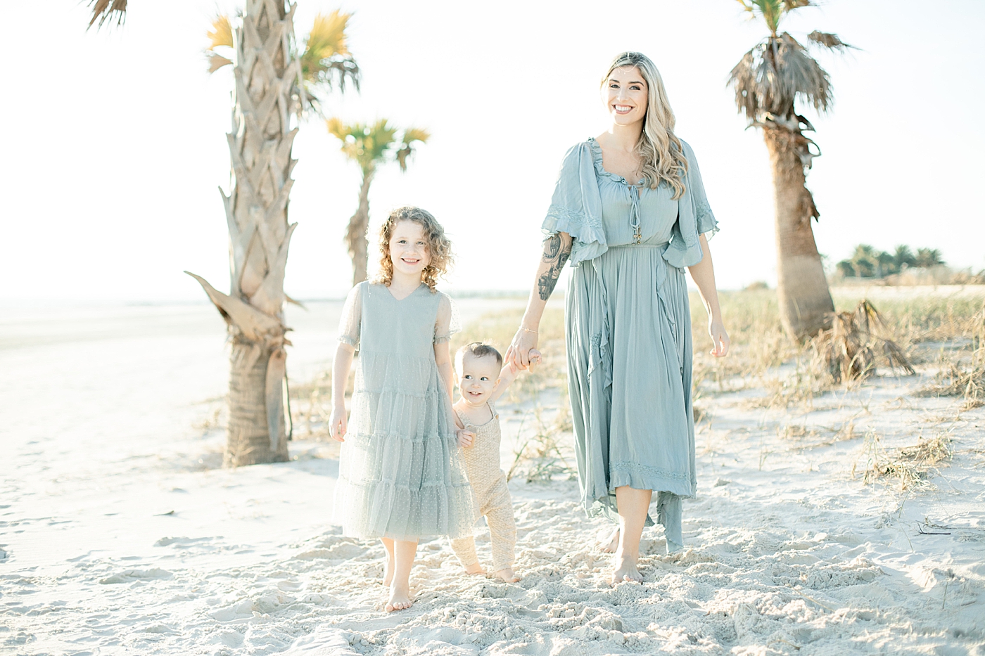 Mom and children walking on the beach | Photo by Ocean Springs Family Photographer Little Sunshine Photography