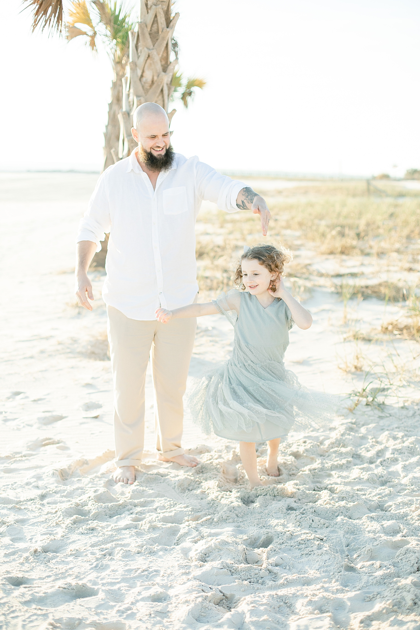 Daddy and daughter dancing on the beach | Photo by Ocean Springs Family Photographer Little Sunshine Photography