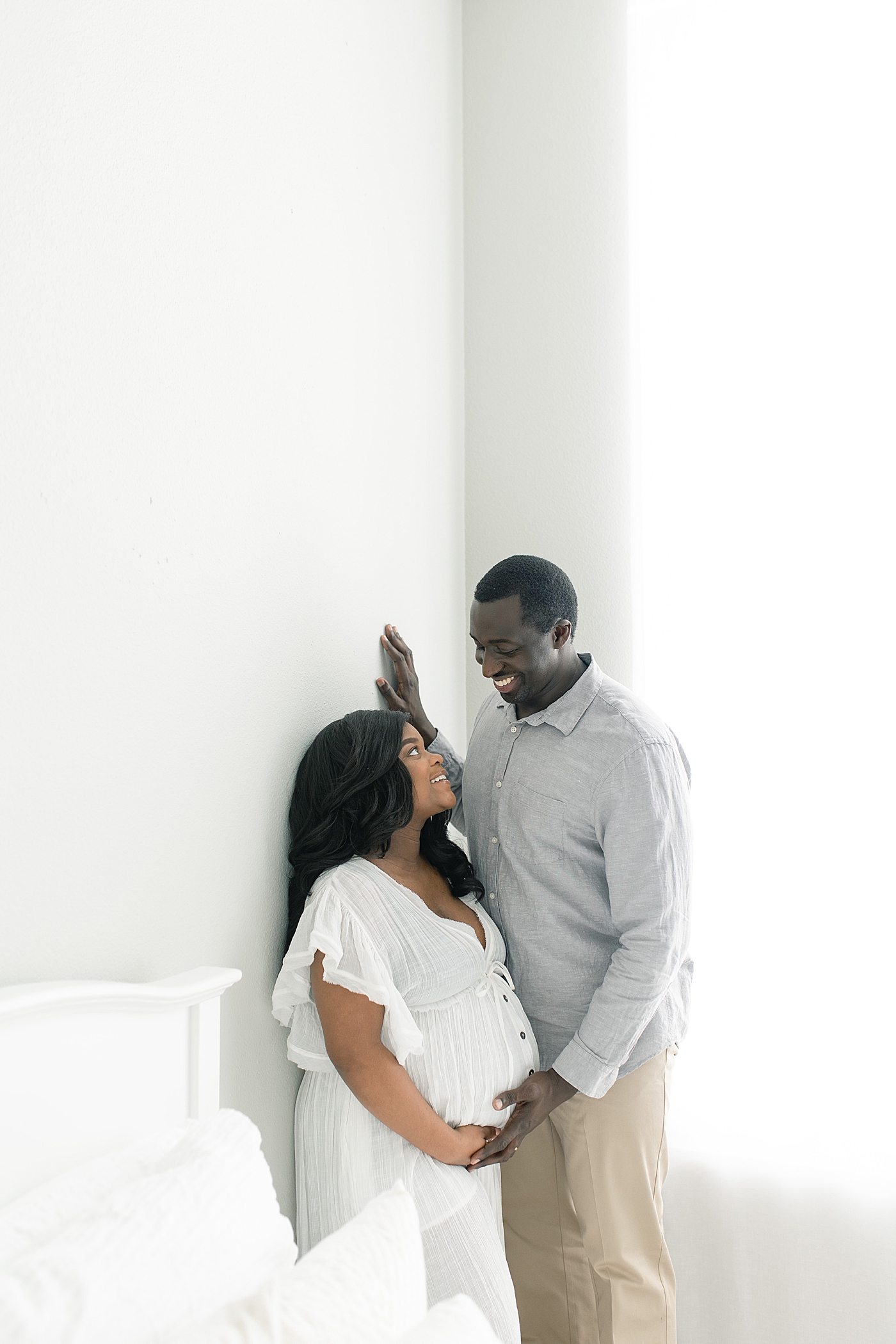 Mother and father to be smiling at each other | Photo by Bay St. Louis Maternity Photographer Little Sunshine Photography