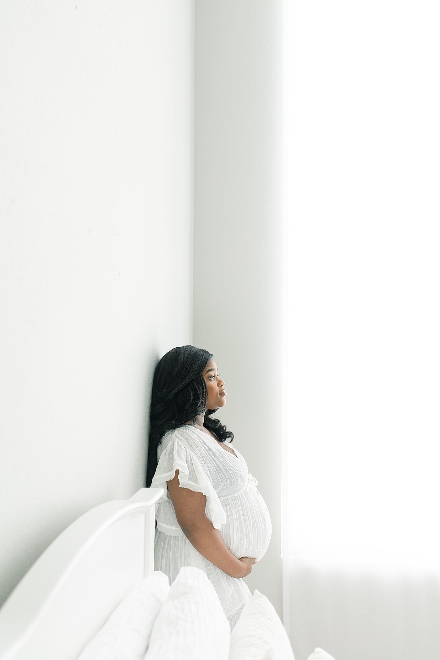Mother to be in a long white dress | Photo by Bay St. Louis Maternity Photographer Little Sunshine Photography