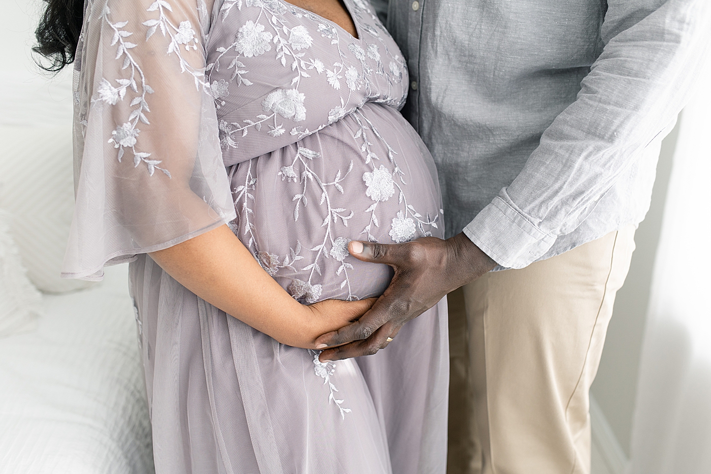 Detail of mother and father to be holding moms belly | Photo by Little Sunshine Photography