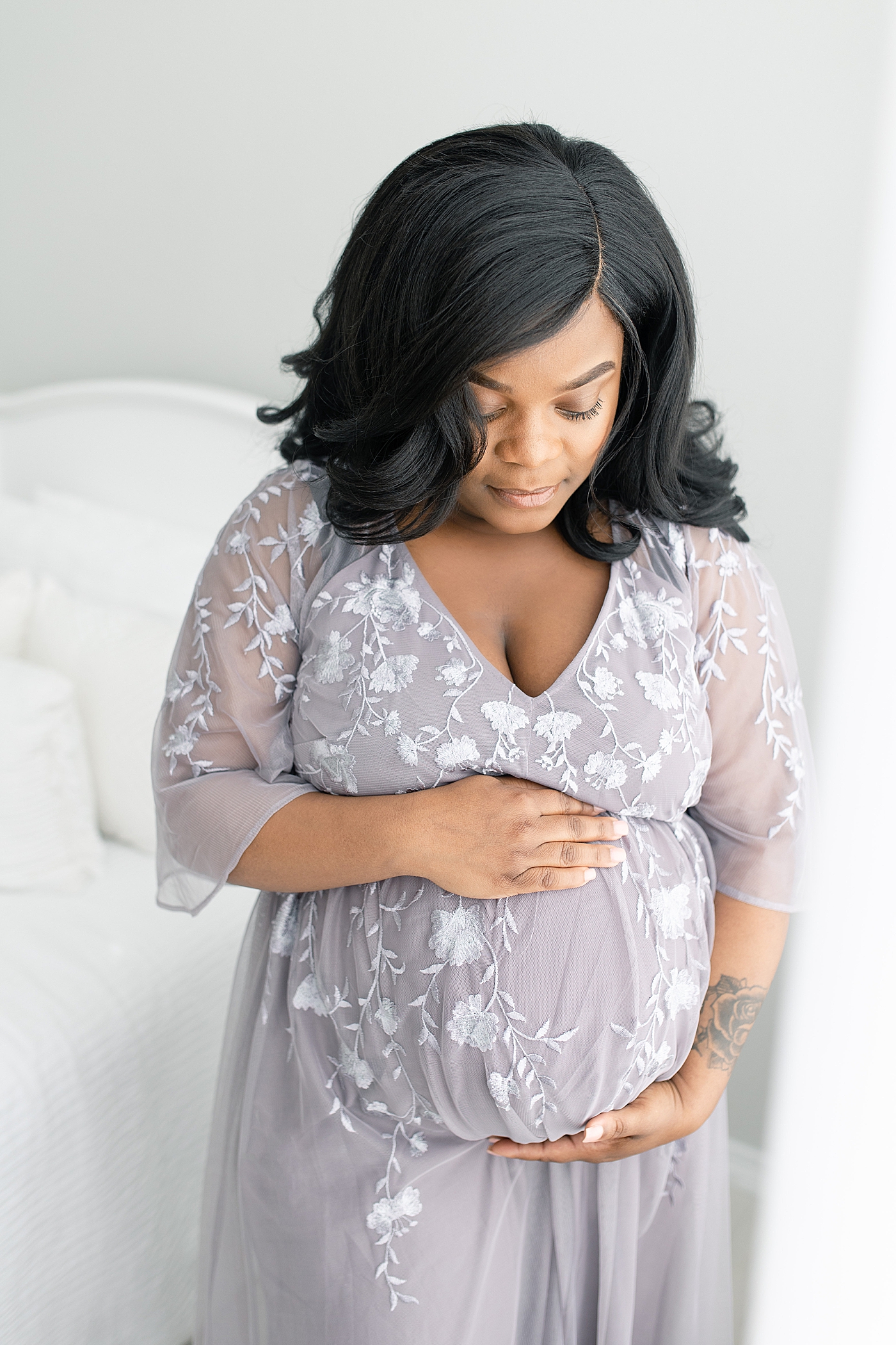 Mother to be looking down at her belly | Photo by Bay St. Louis Maternity Photographer Little Sunshine Photography