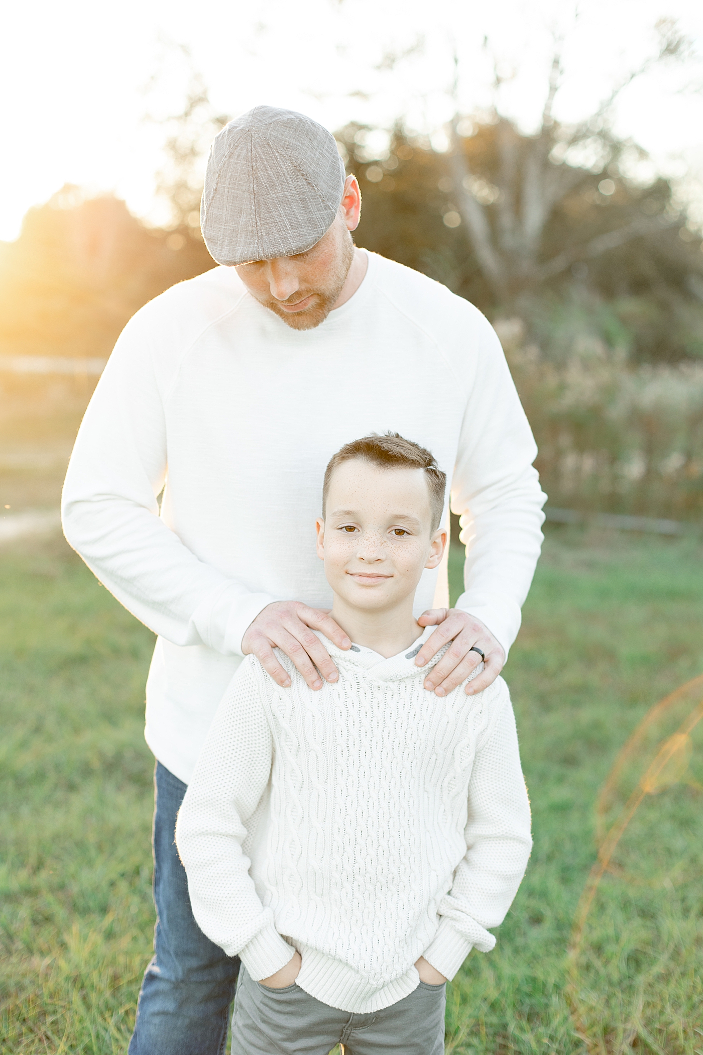 Little boy standing with his dad in matching cream shirts | Photo by Gulfport baby photographer Little Sunshine Photography