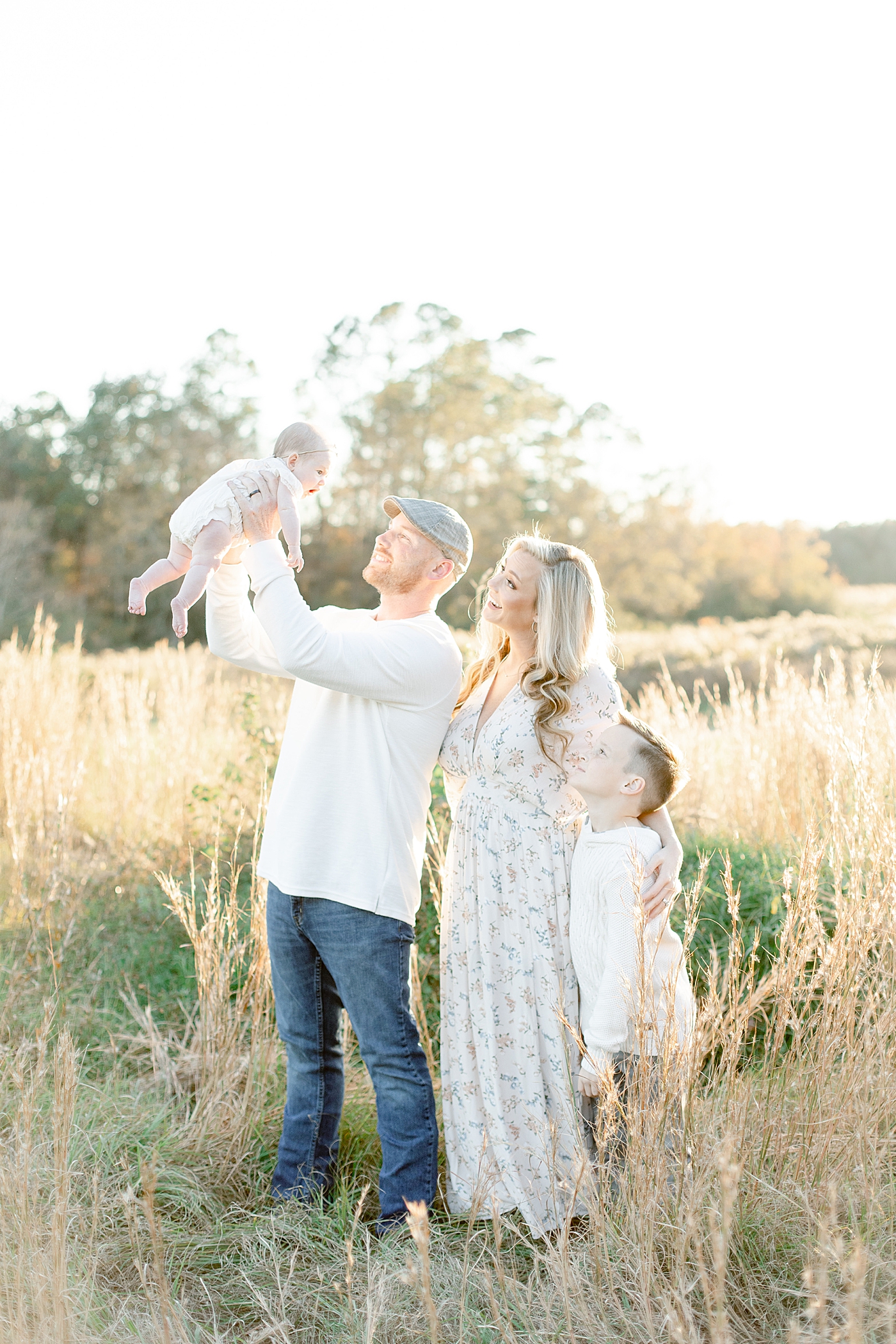 Family of four in a field | Photo by Gulfport baby photographer Little Sunshine Photography