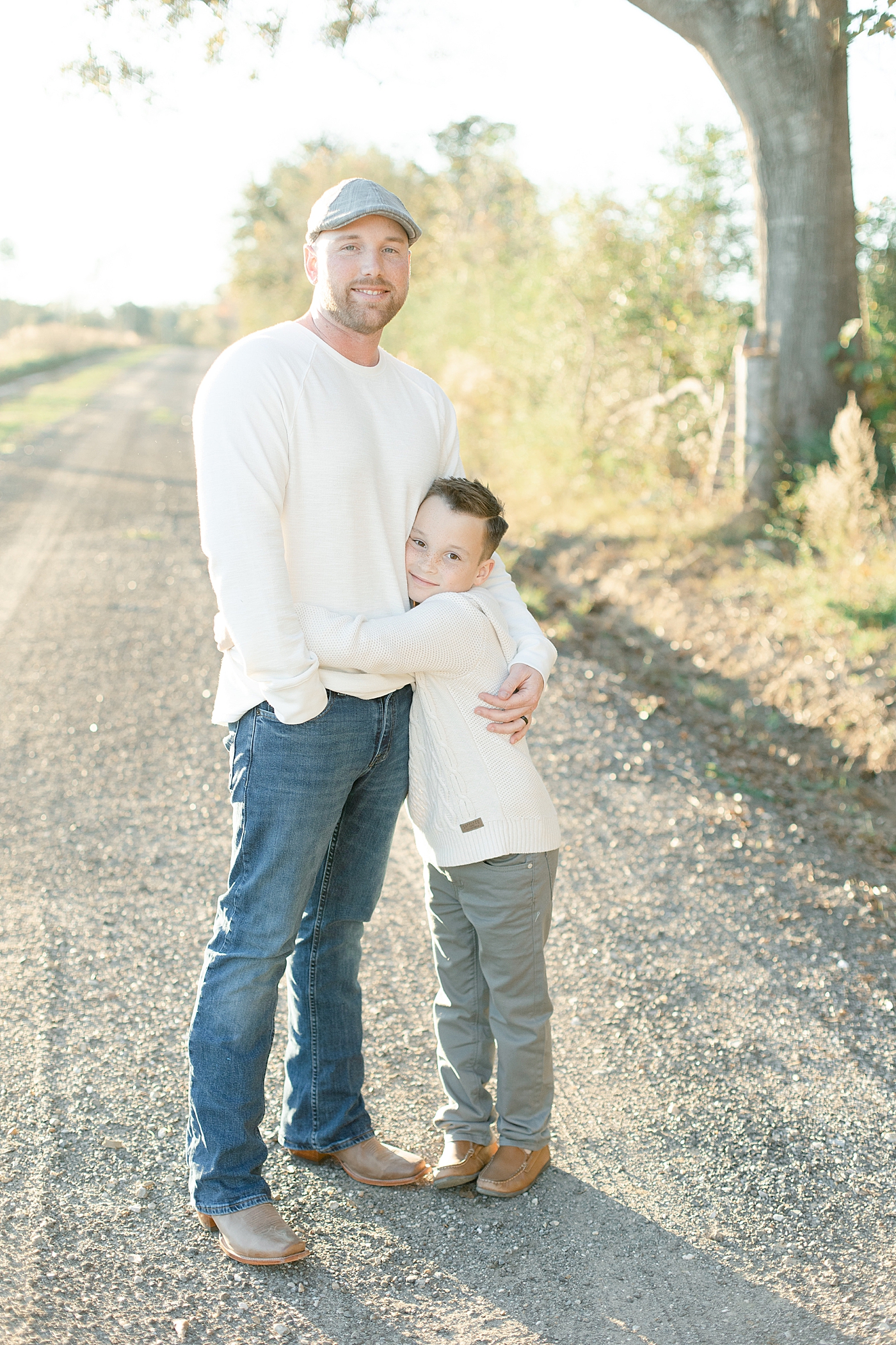 Little boy in cream shirt hugging his dad | Photo by Gulfport baby photographer Little Sunshine Photography