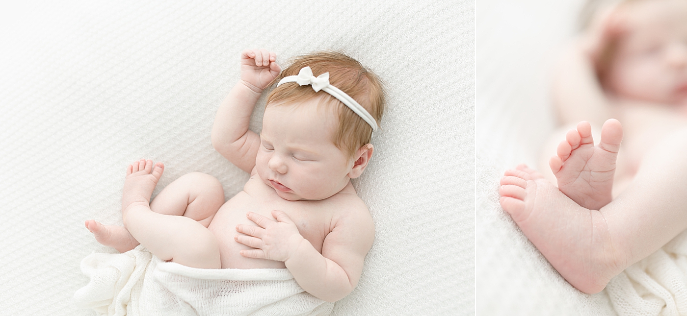 Sleeping baby girl in white bow and swaddle | Photo by Little Sunshine Photography